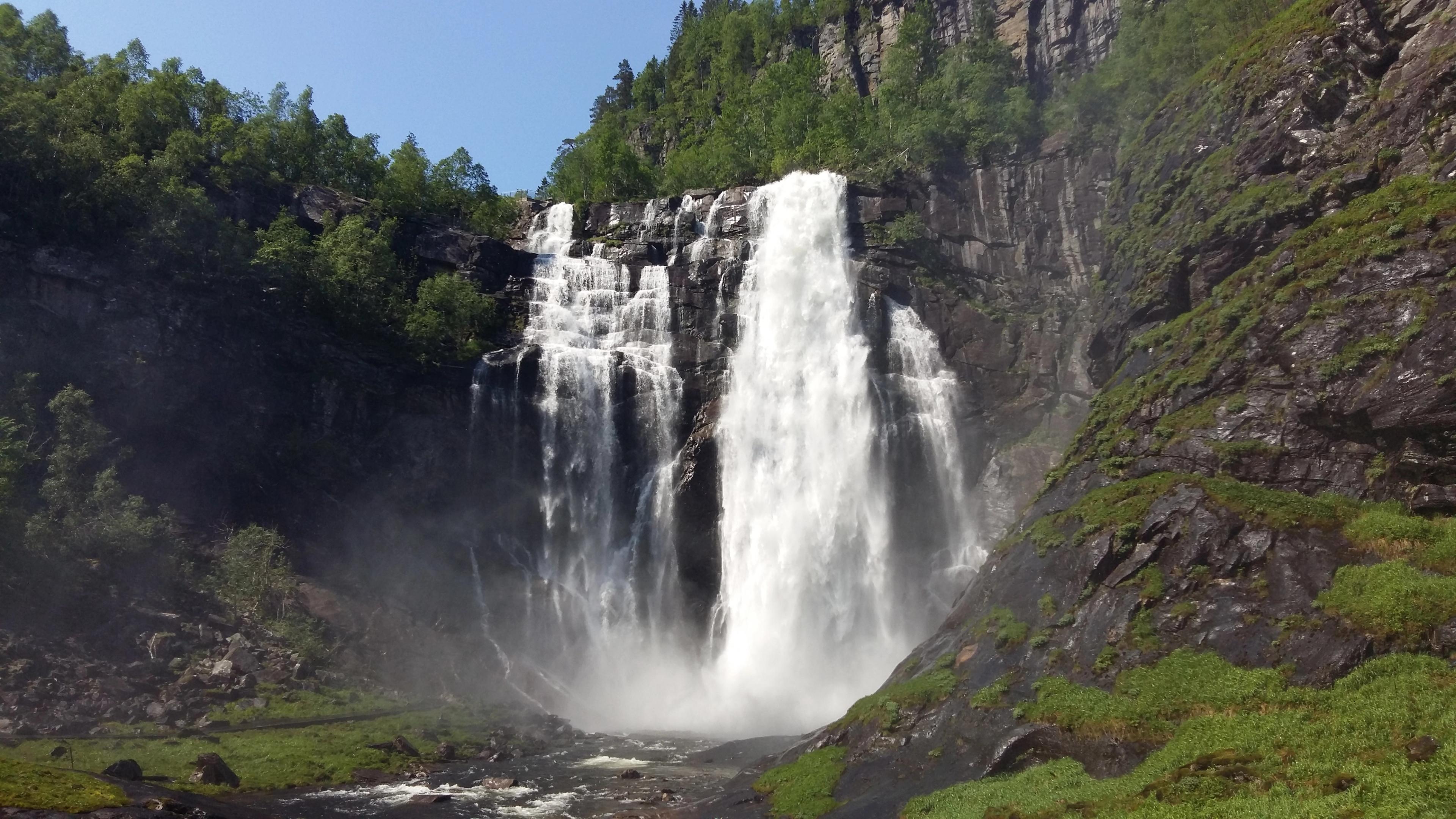 A tall waterfall in the mountains