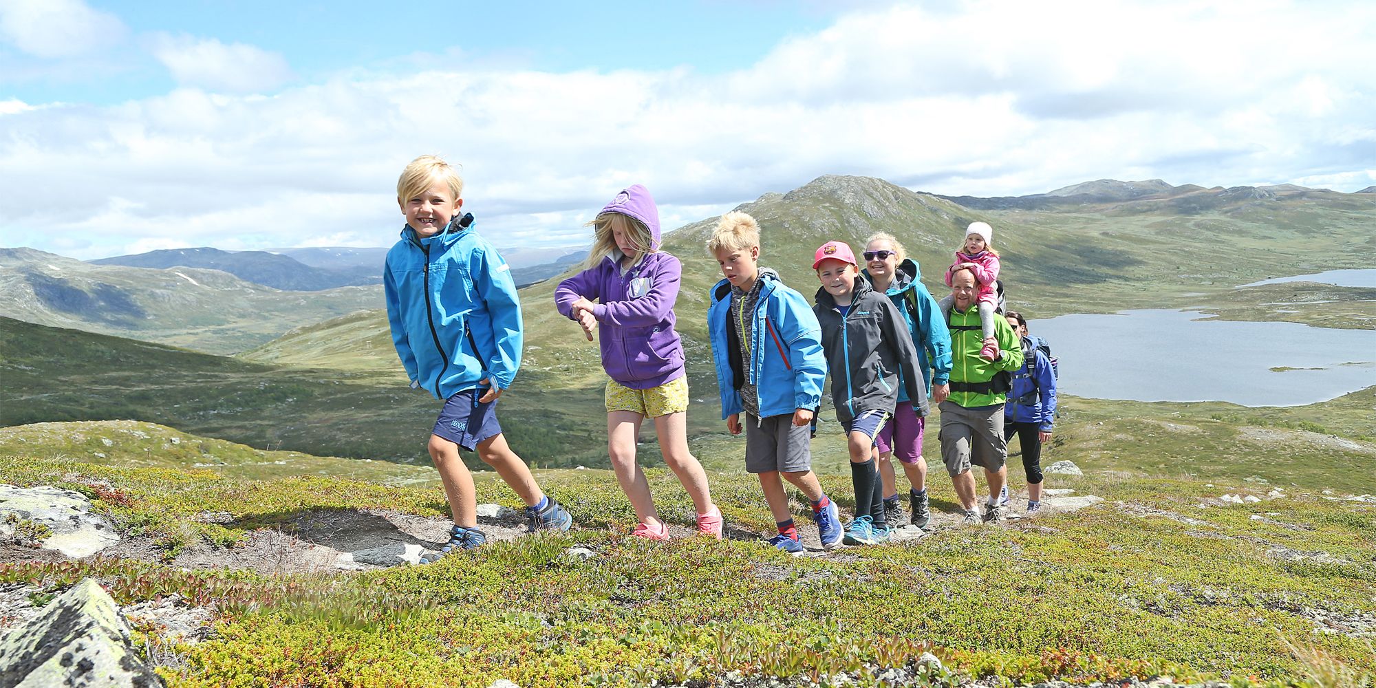 A group of adults and children hiking in the Hemsedal mountains in Eastern Norway