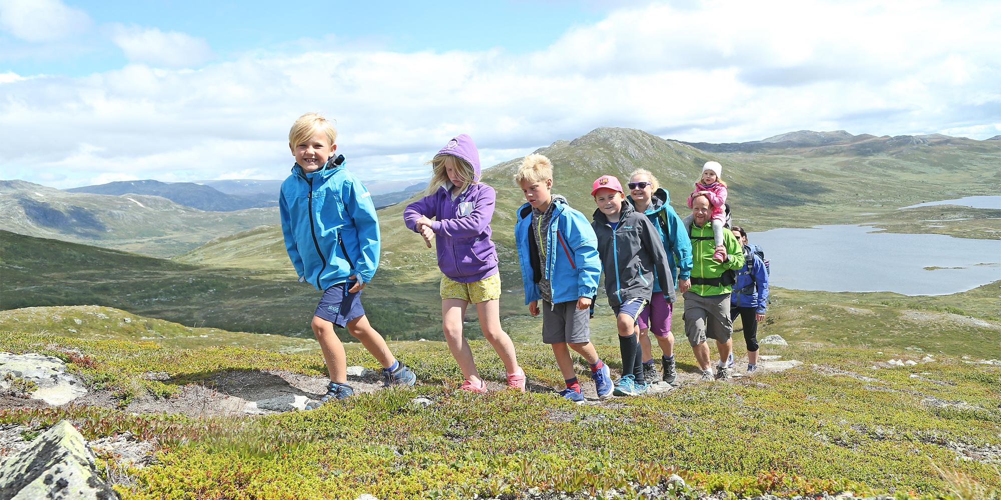 A group of adults and children hiking in the Hemsedal mountains in Eastern Norway