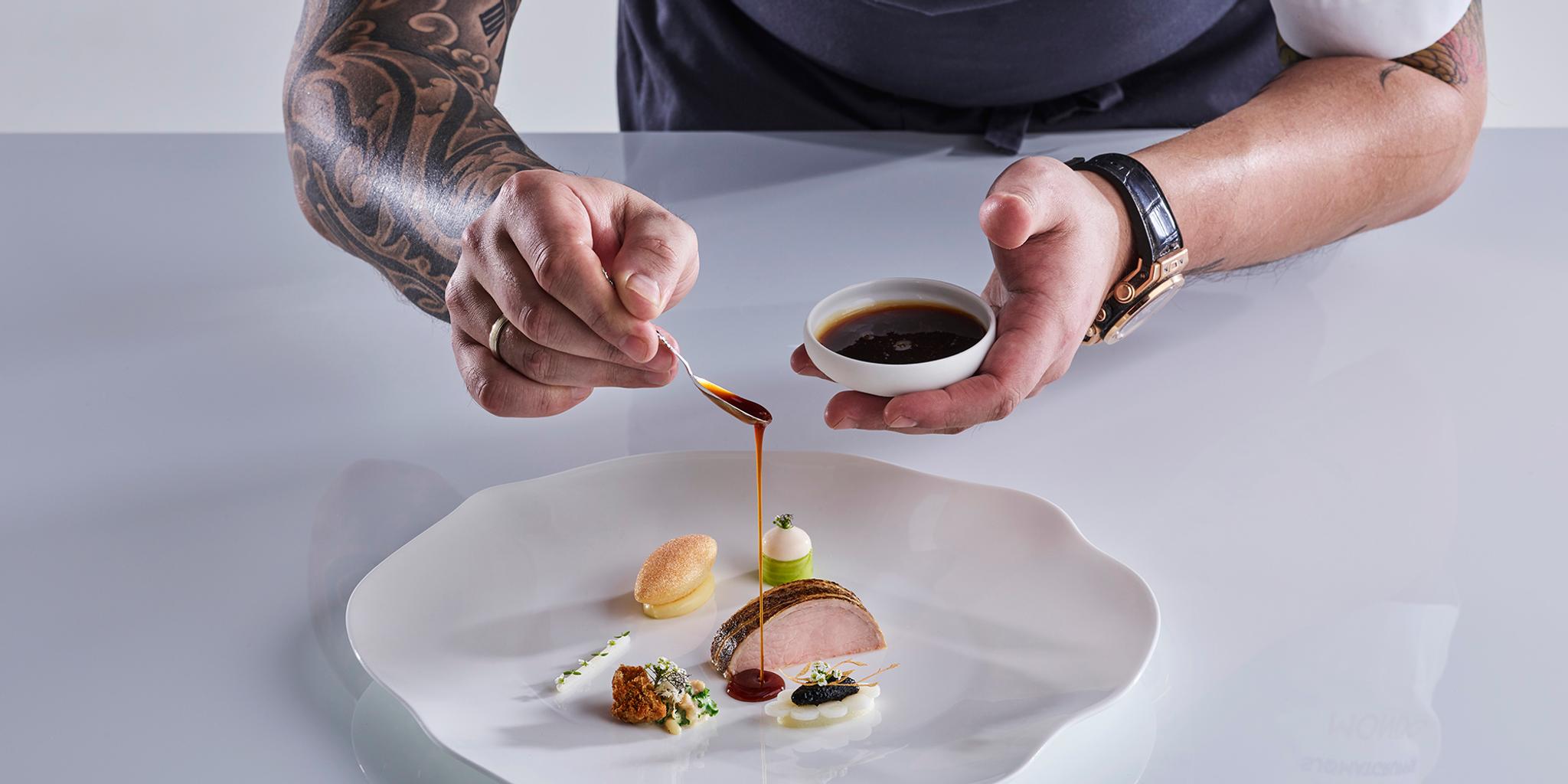 Norwegian chef Christian André Pettersen arranging food on a plate in Bocuse d’Or 2019