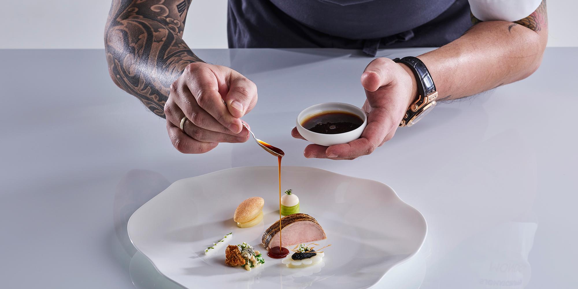 Norwegian chef Christian André Pettersen arranging food on a plate in Bocuse d’Or 2019