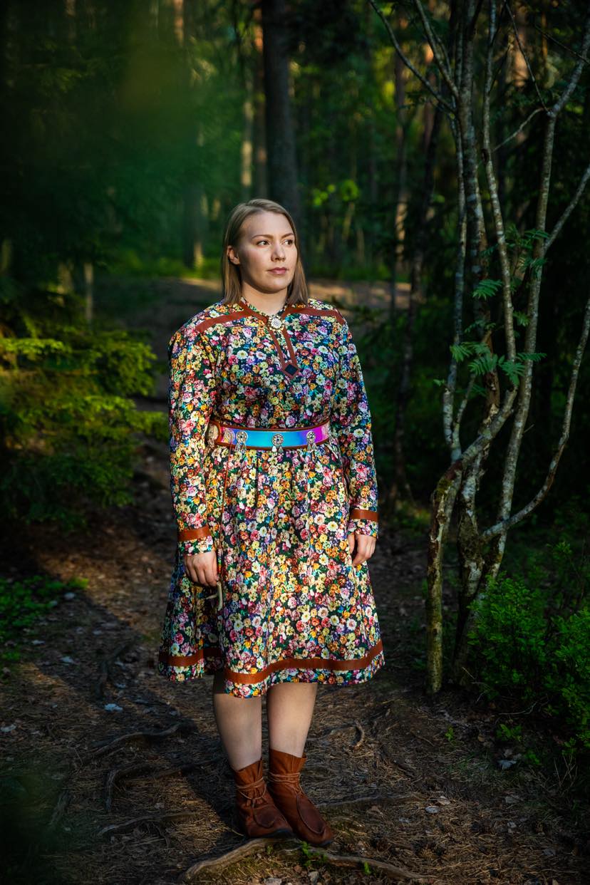 Eirin Roseneng in the woods in a colourful Sami inspired design.