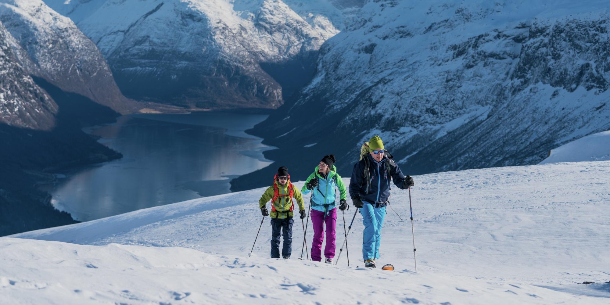 Three people ski touring at Mount Hoven in Loen in Nordfjord, Fjord Norway