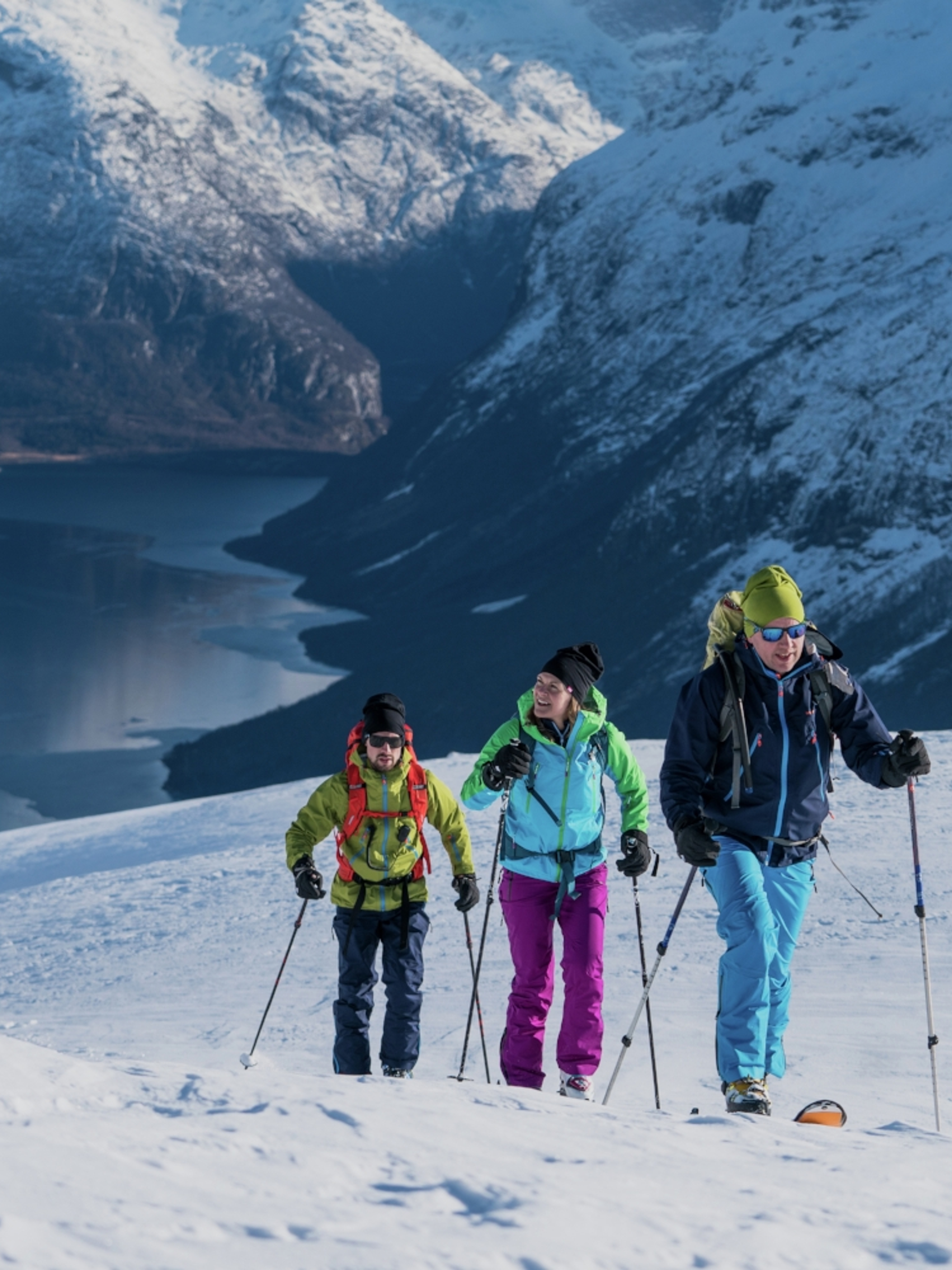 Three people ski touring at Mount Hoven in Loen in Nordfjord, Fjord Norway