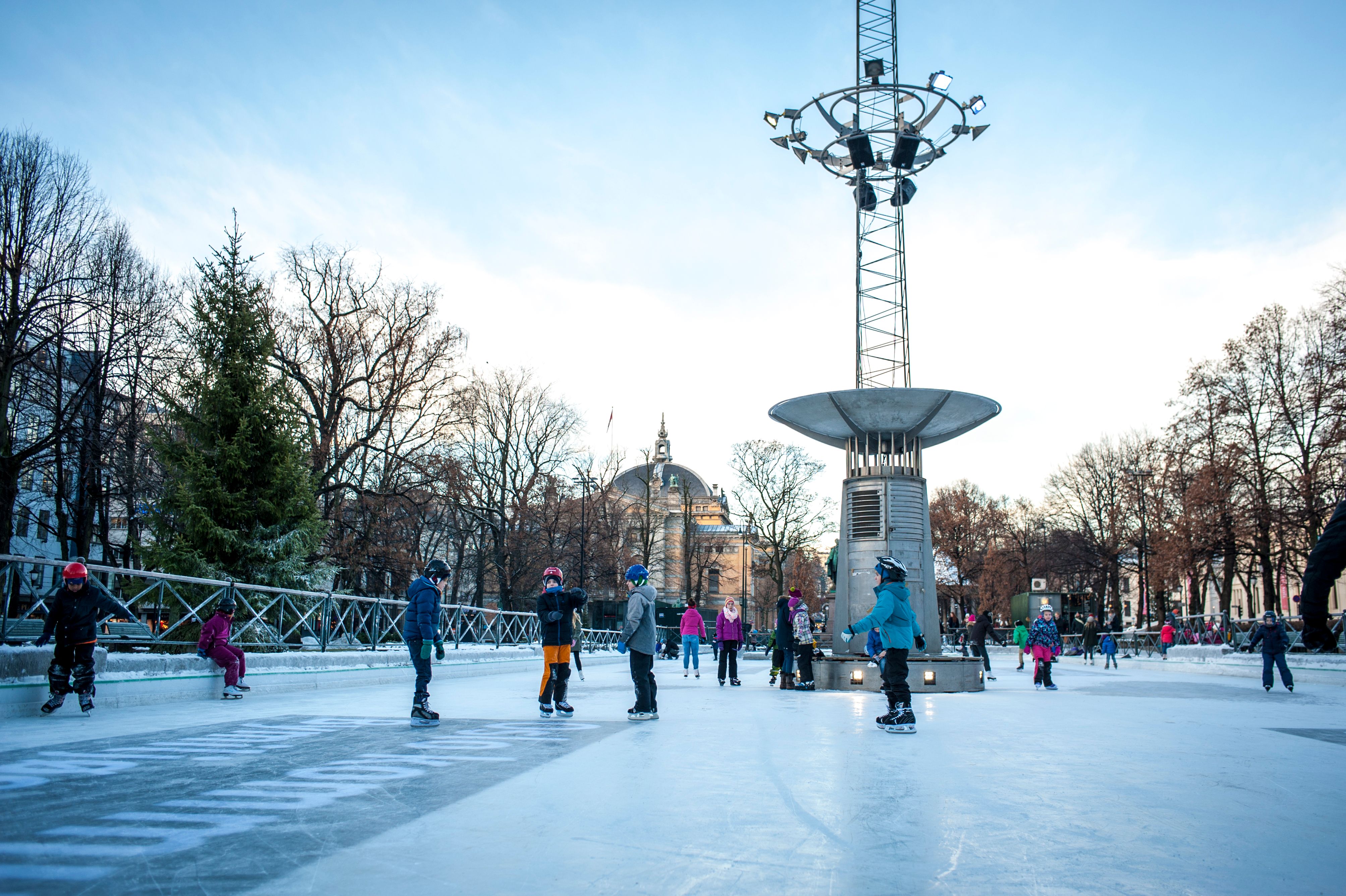 Kids ice skating at the ice rink in the middle of Oslo city, Norway
