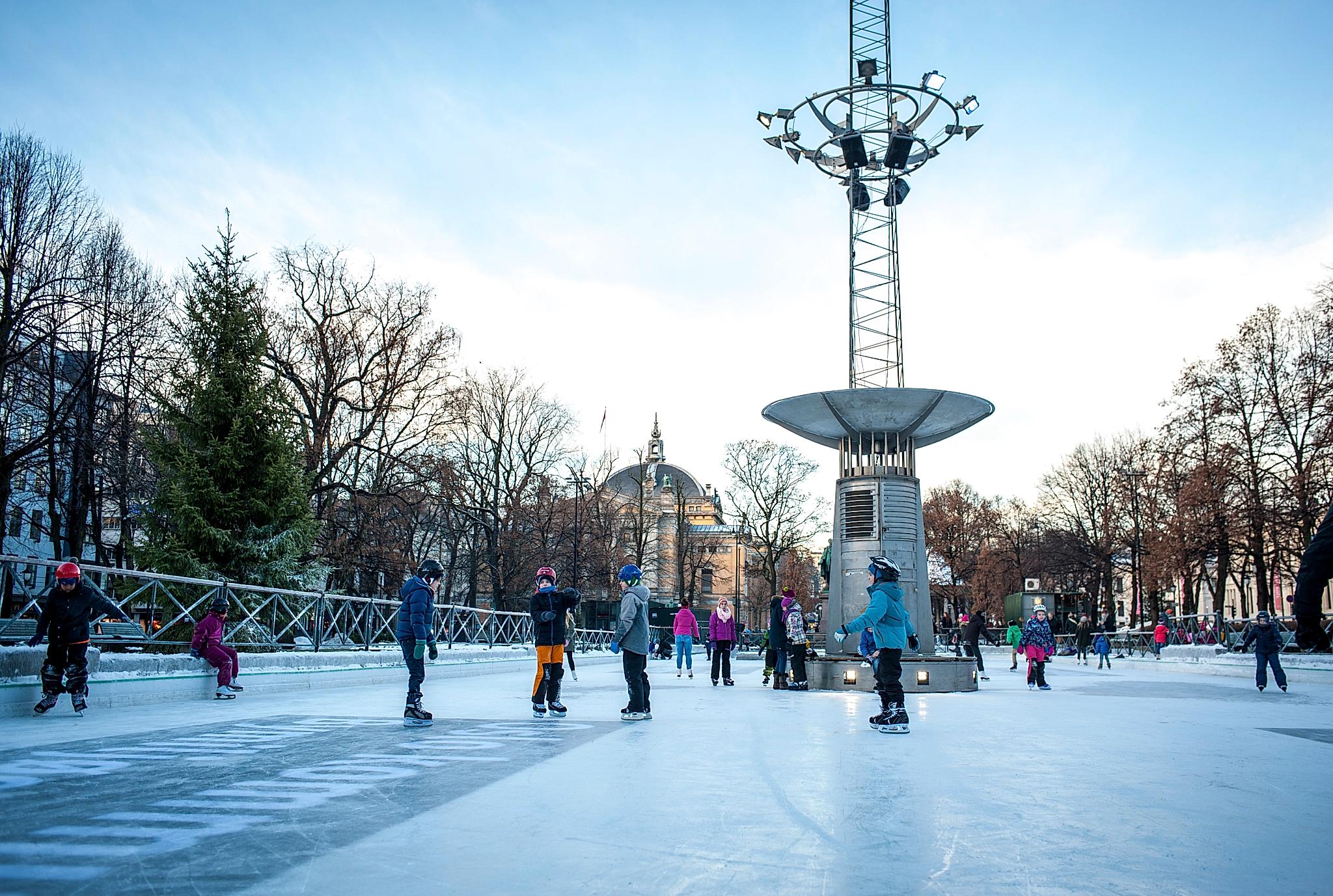 Kids ice skating at the ice rink in the middle of Oslo city, Norway