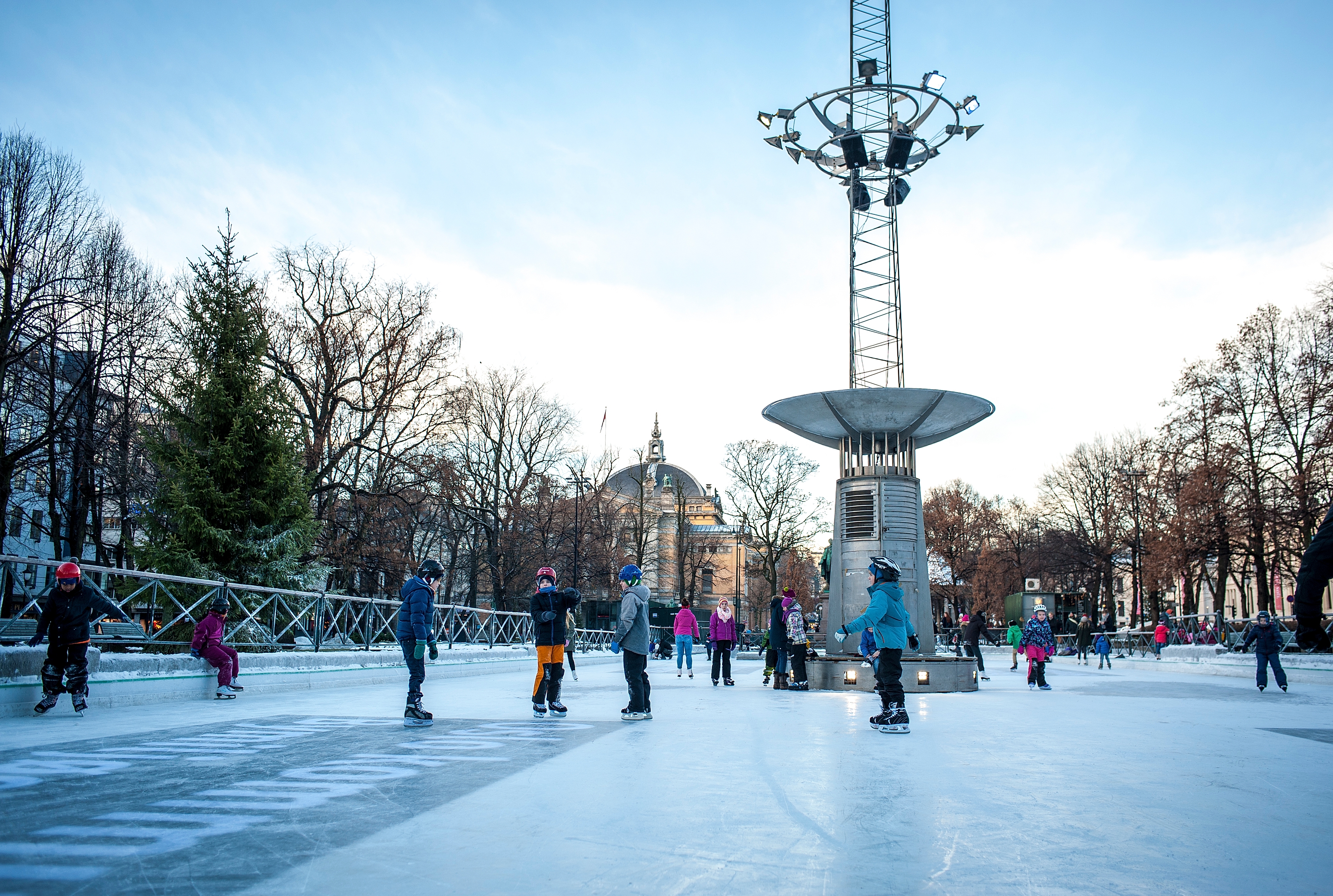Kids ice skating at the ice rink in the middle of Oslo city, Norway