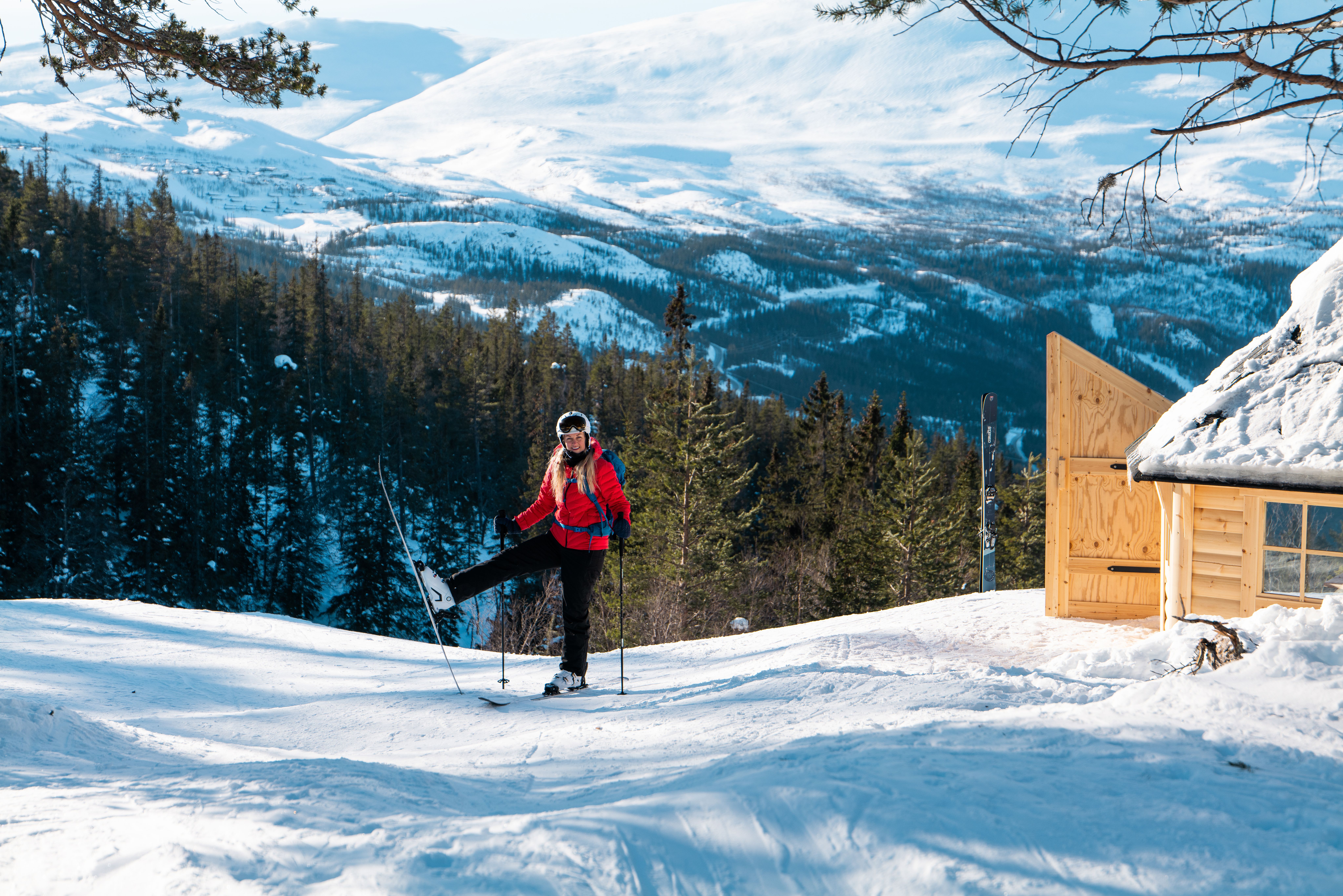 Woman on skis outside cabin in Telemark
