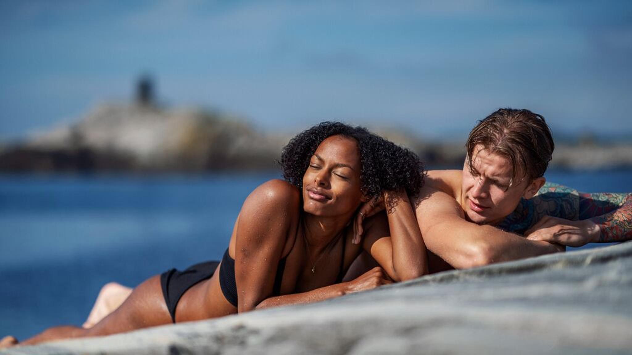 Couple sunbathing in Norway
