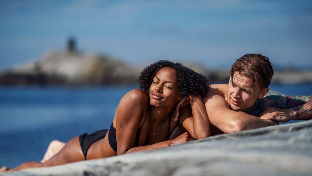 Couple sunbathing in Norway