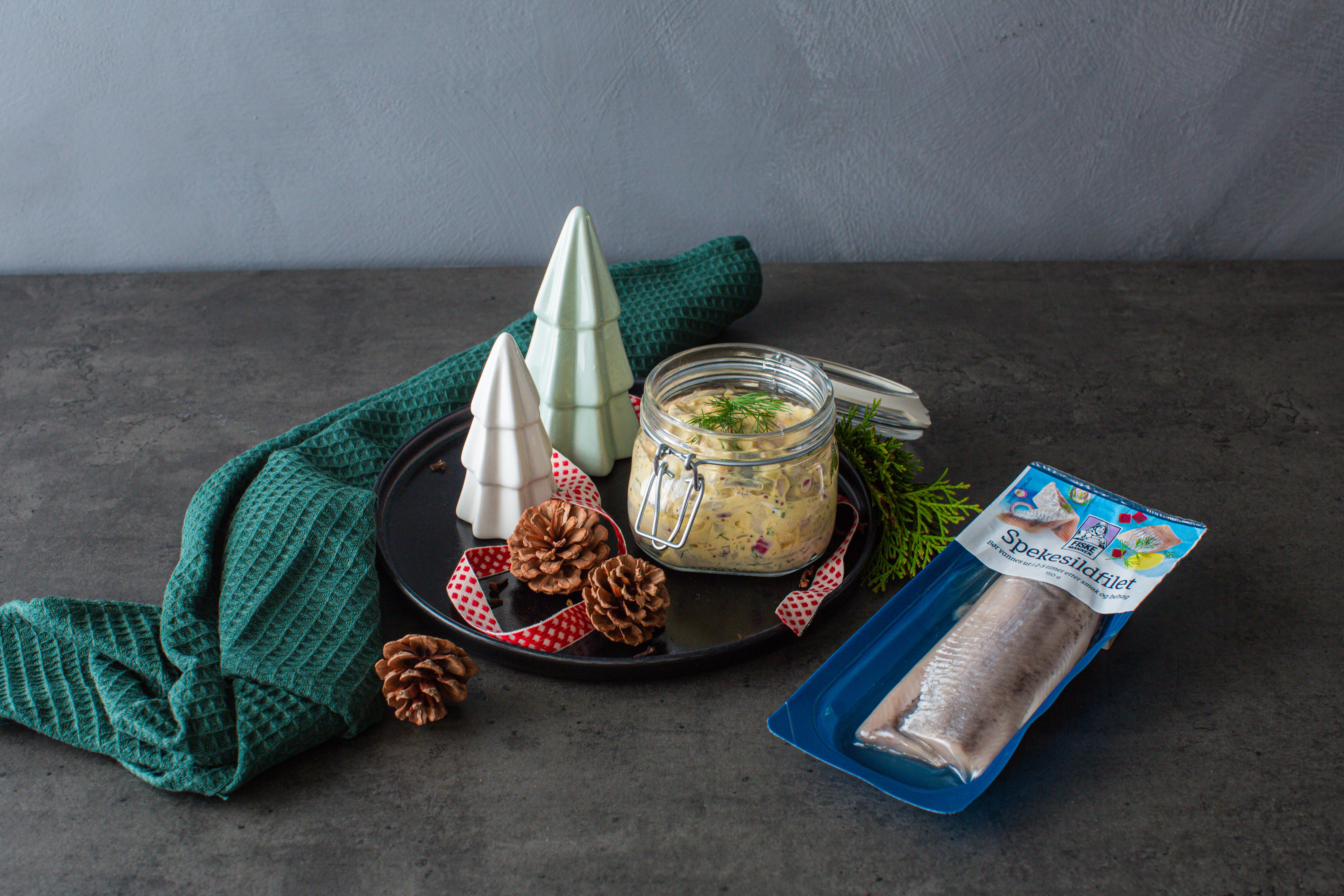 Traditional Norwegian pickled herring in a glass jar.