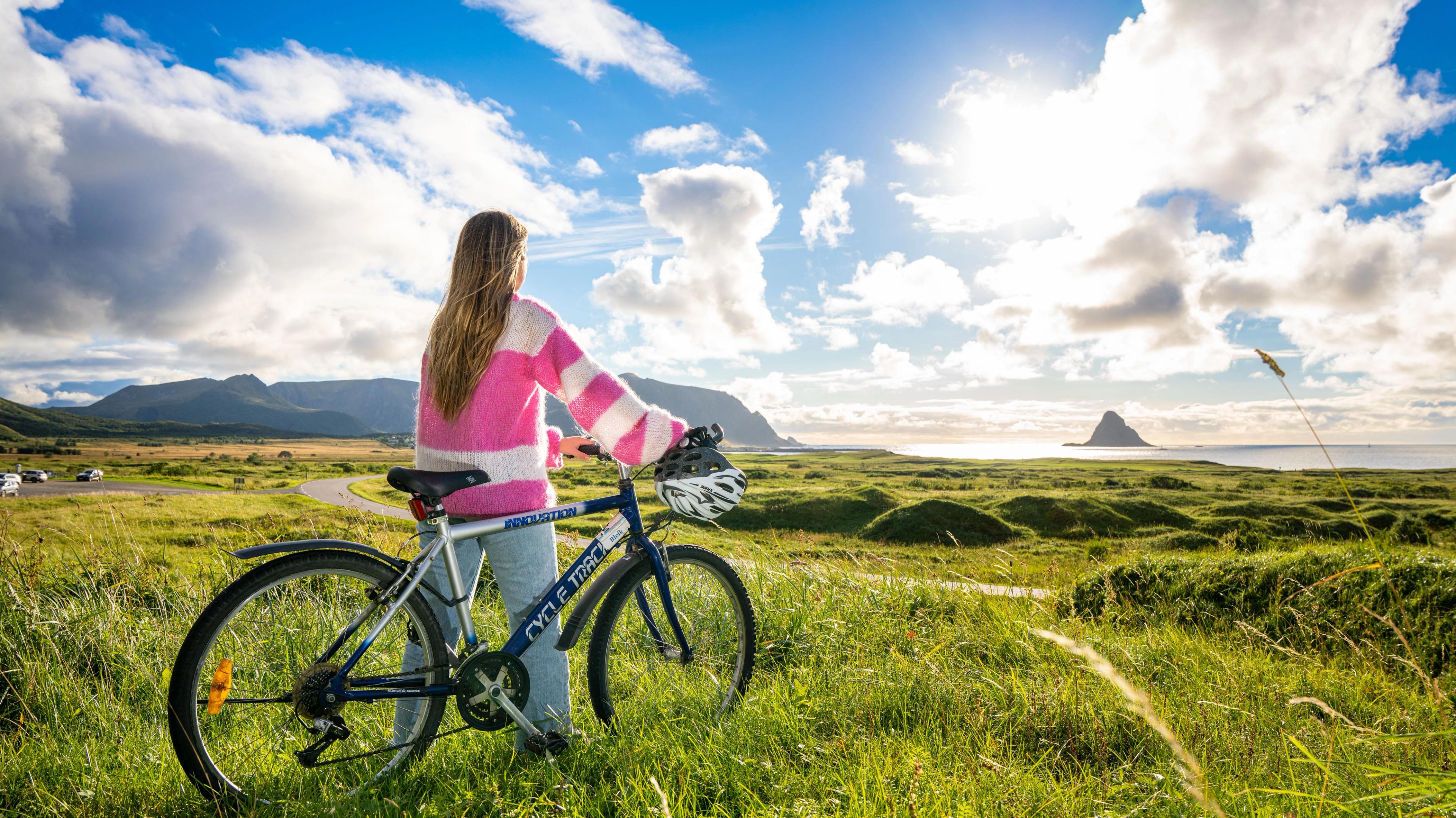 A woman biking along Norwegian Scenic Route Andøya in Vesterålen
