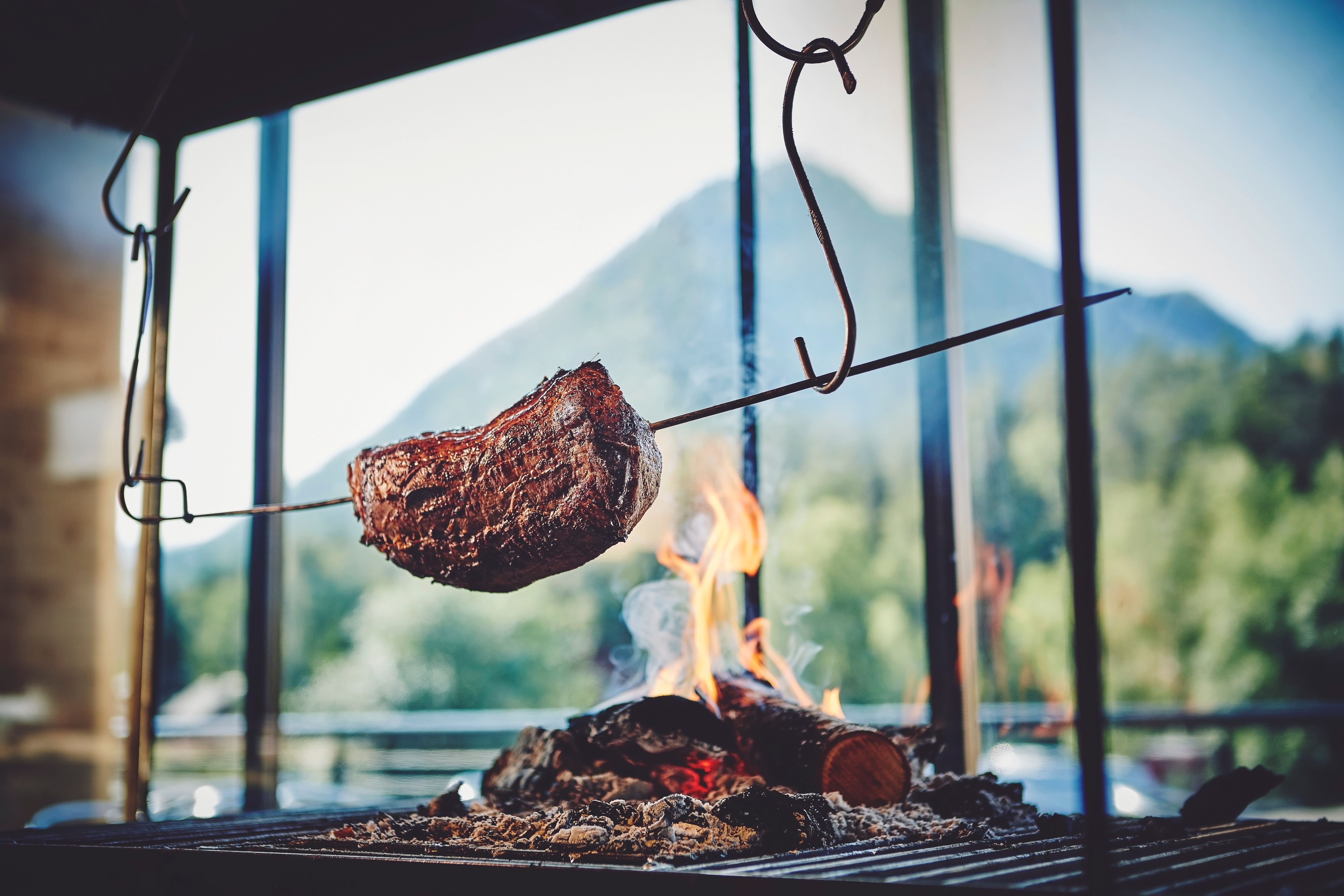 Meat getting cooked over fire at BrimiBue Hotel in Lom