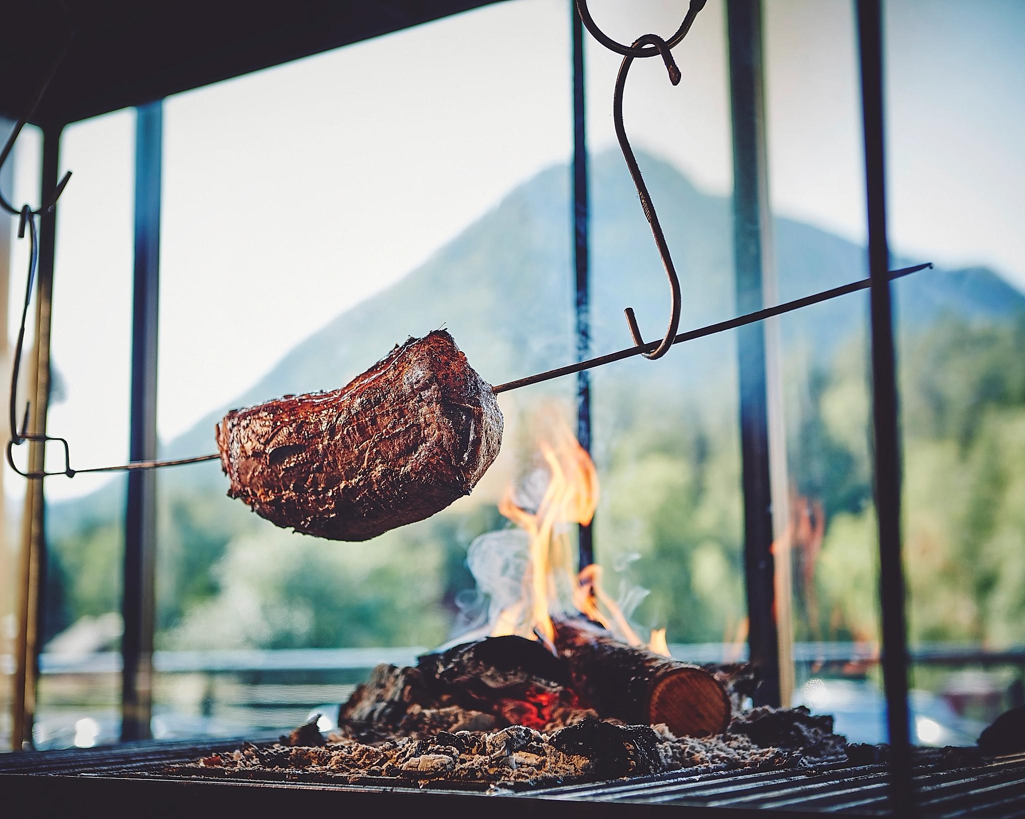 Meat getting cooked over fire at BrimiBue Hotel in Lom