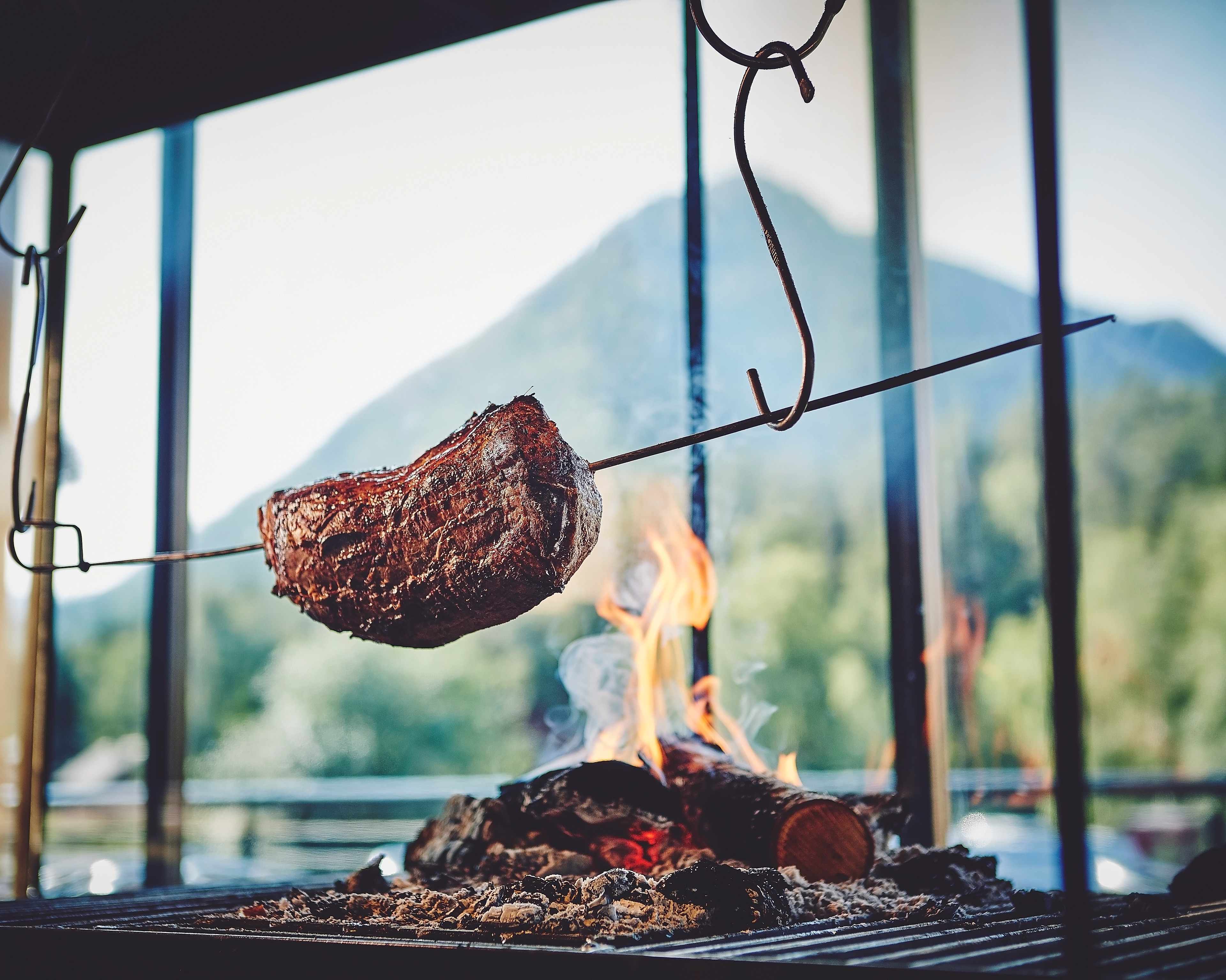 Meat getting cooked over fire at BrimiBue Hotel in Lom
