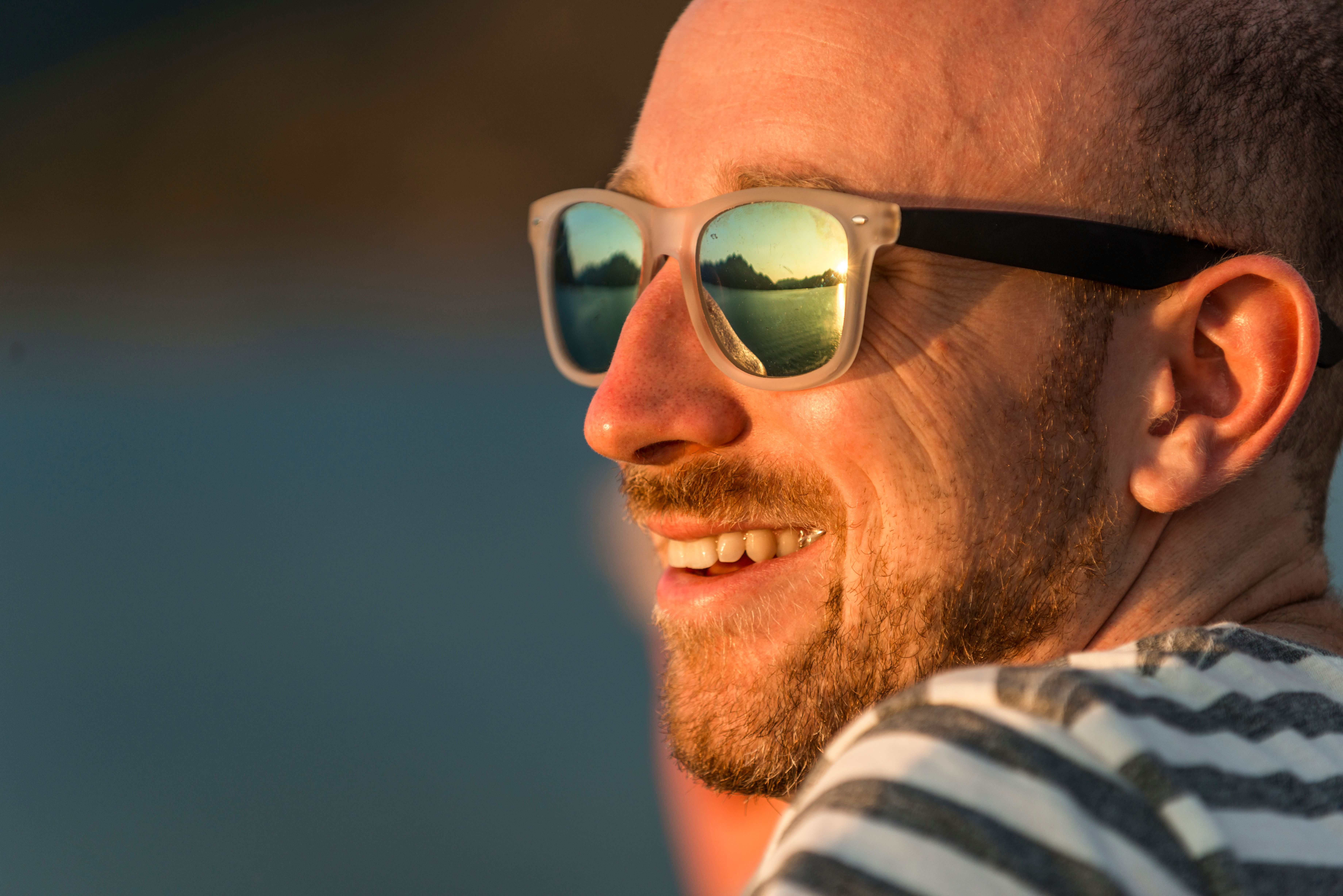 Close-up of the face of a man in sunglasses. Hurtigruten, Norway