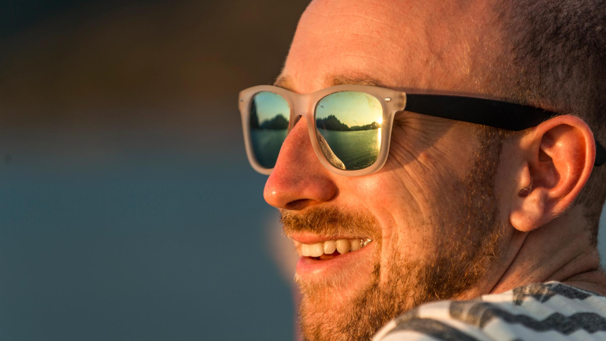 Close-up of the face of a man in sunglasses. Hurtigruten, Norway