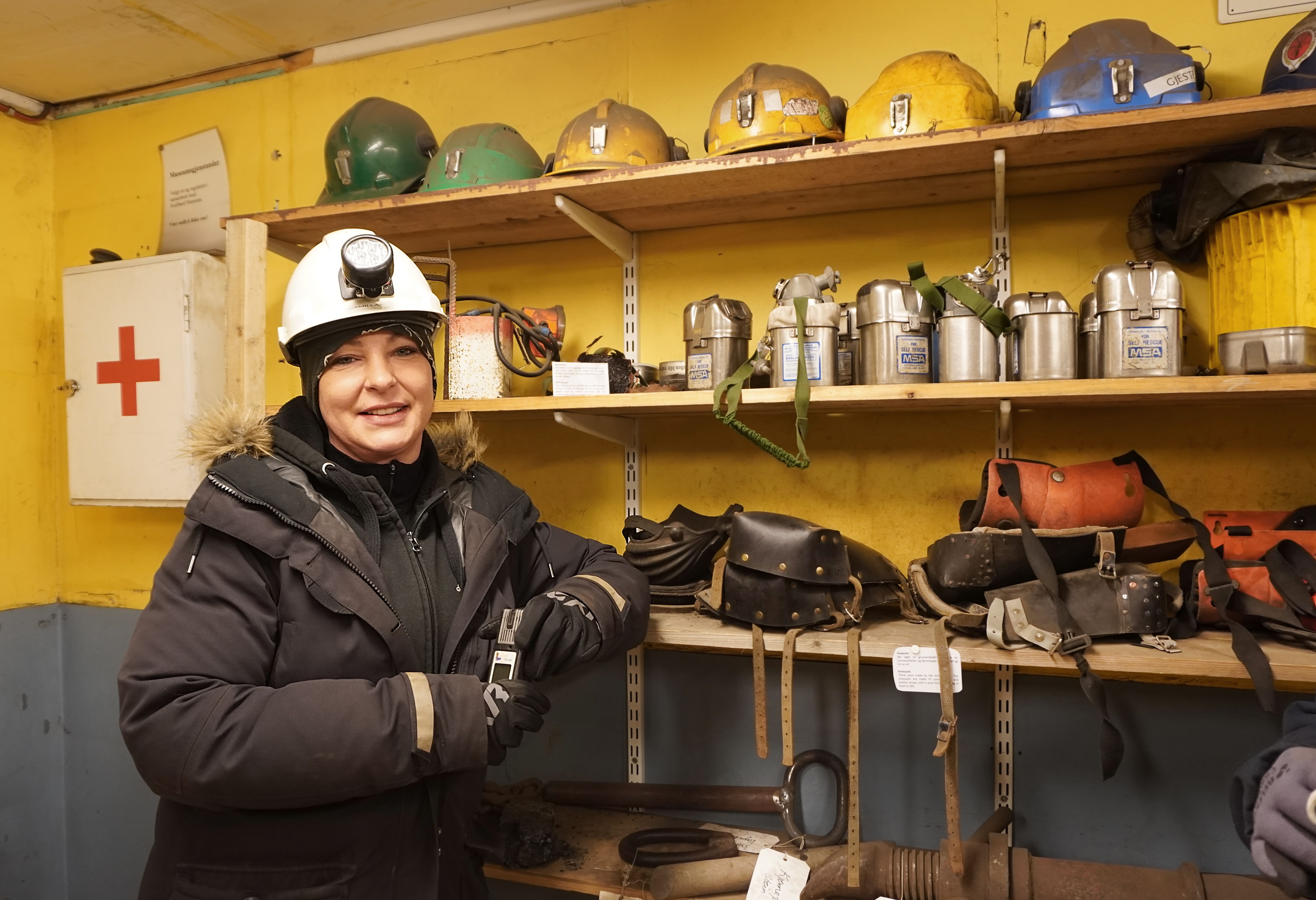 A woman with helmet in a mine