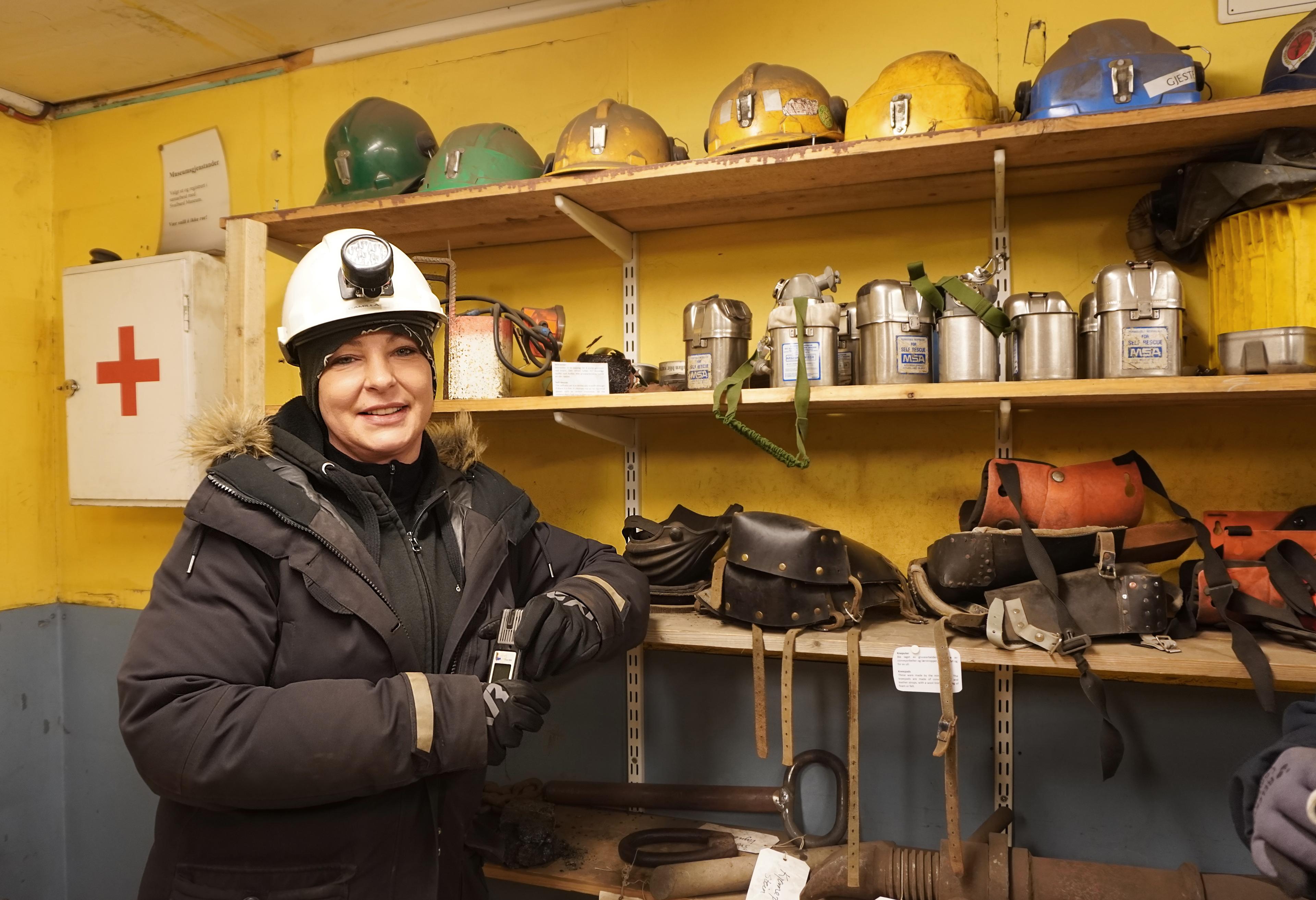 A woman with helmet in a mine