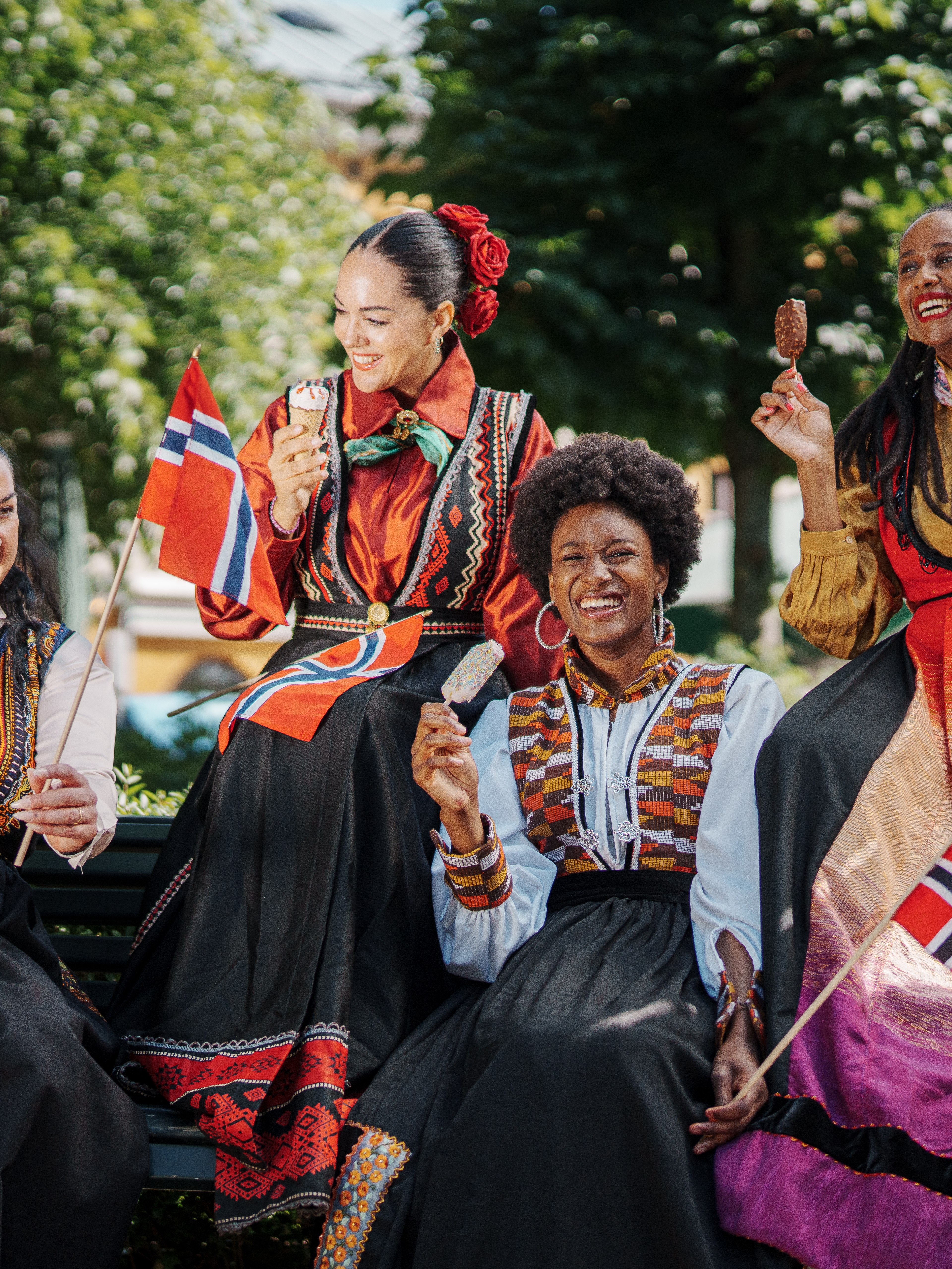 Four women in inclusive festive costumes.