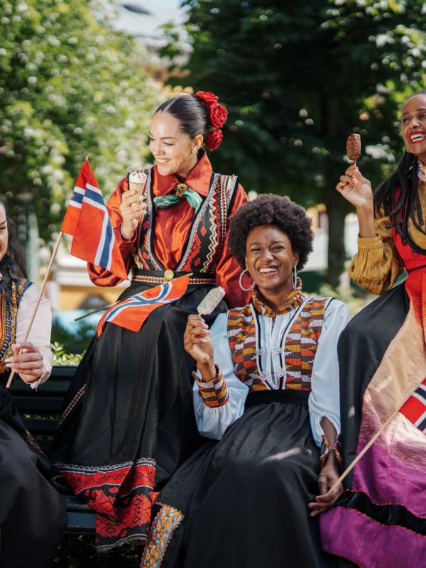 Four women in inclusive festive costumes.