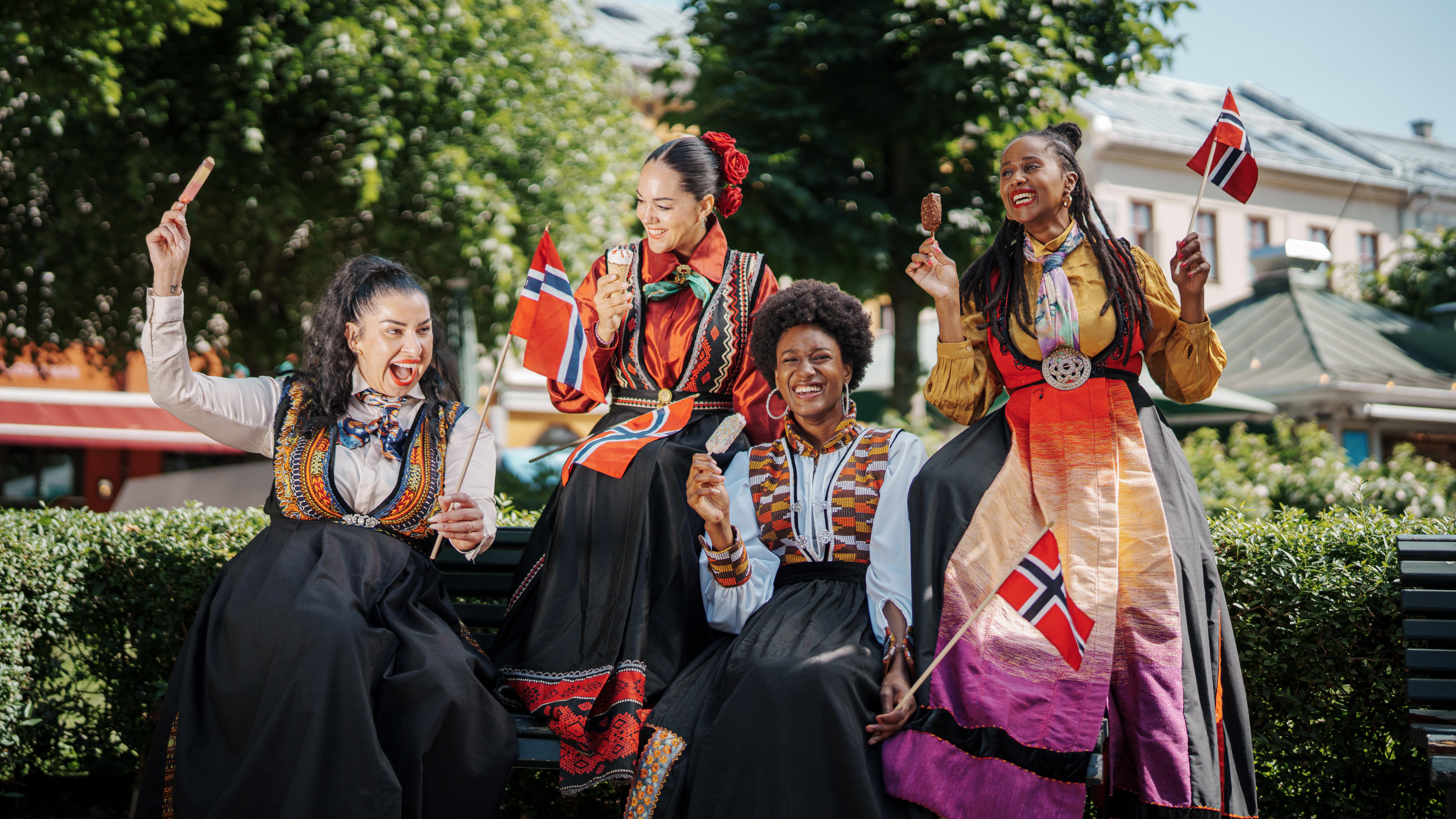 Four women in inclusive festive costumes.