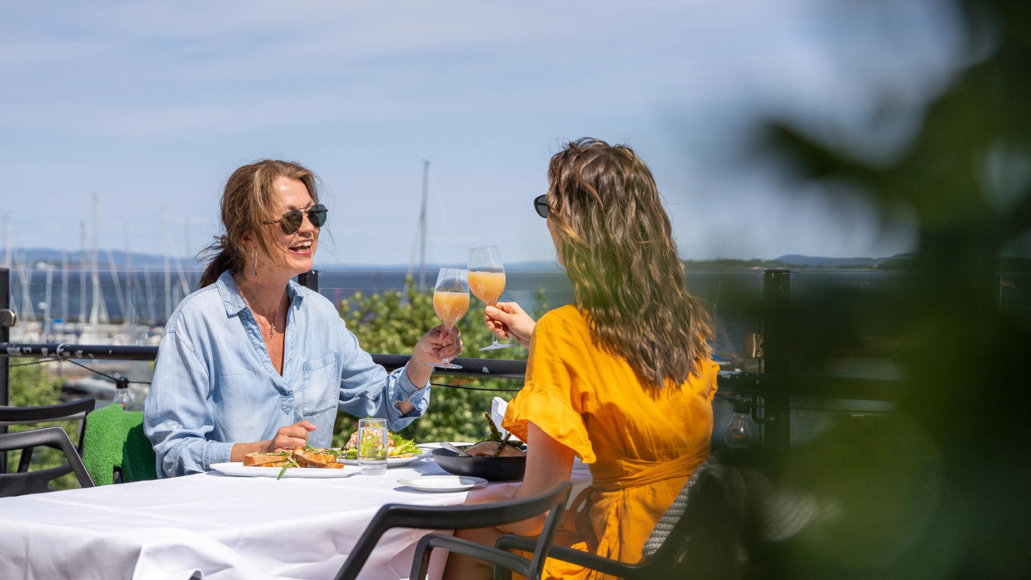 Two women having dinner at The Grand Hotel Åsgårdstrand, in Vestfold