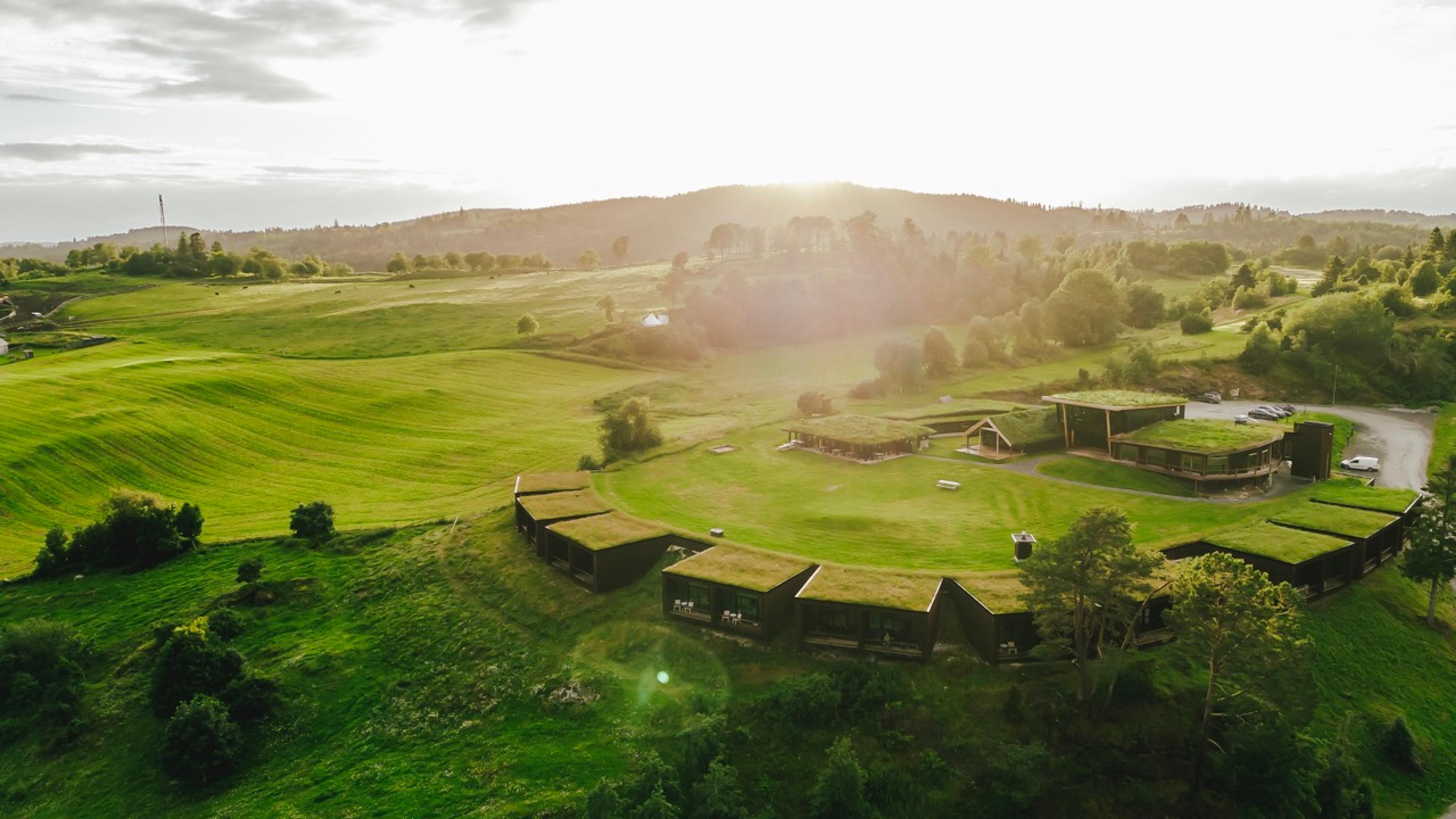 A hotel submerged in a green hill