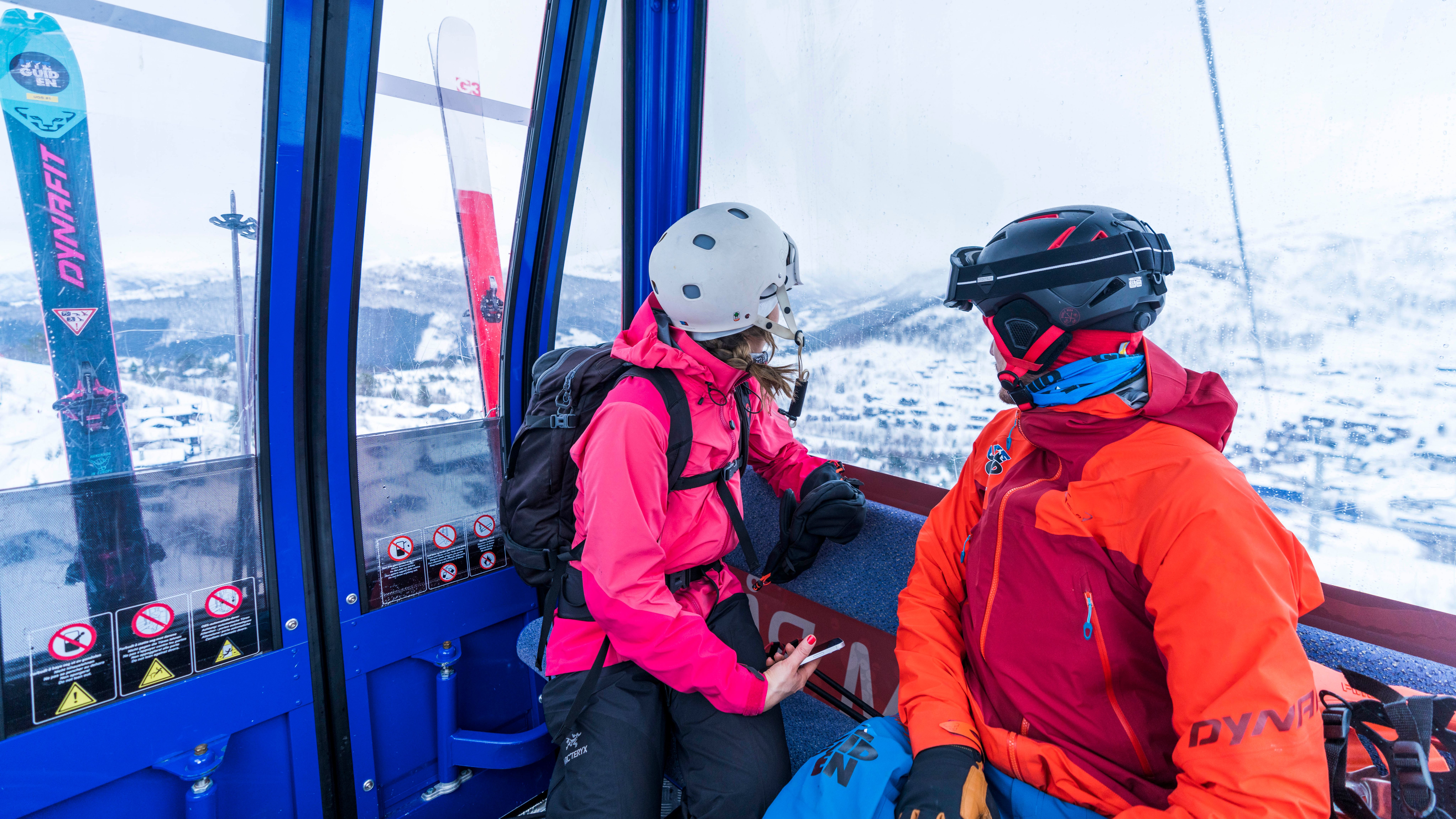 Two people sitting in the Gondola at Strandafjellet, in Fjord Norway