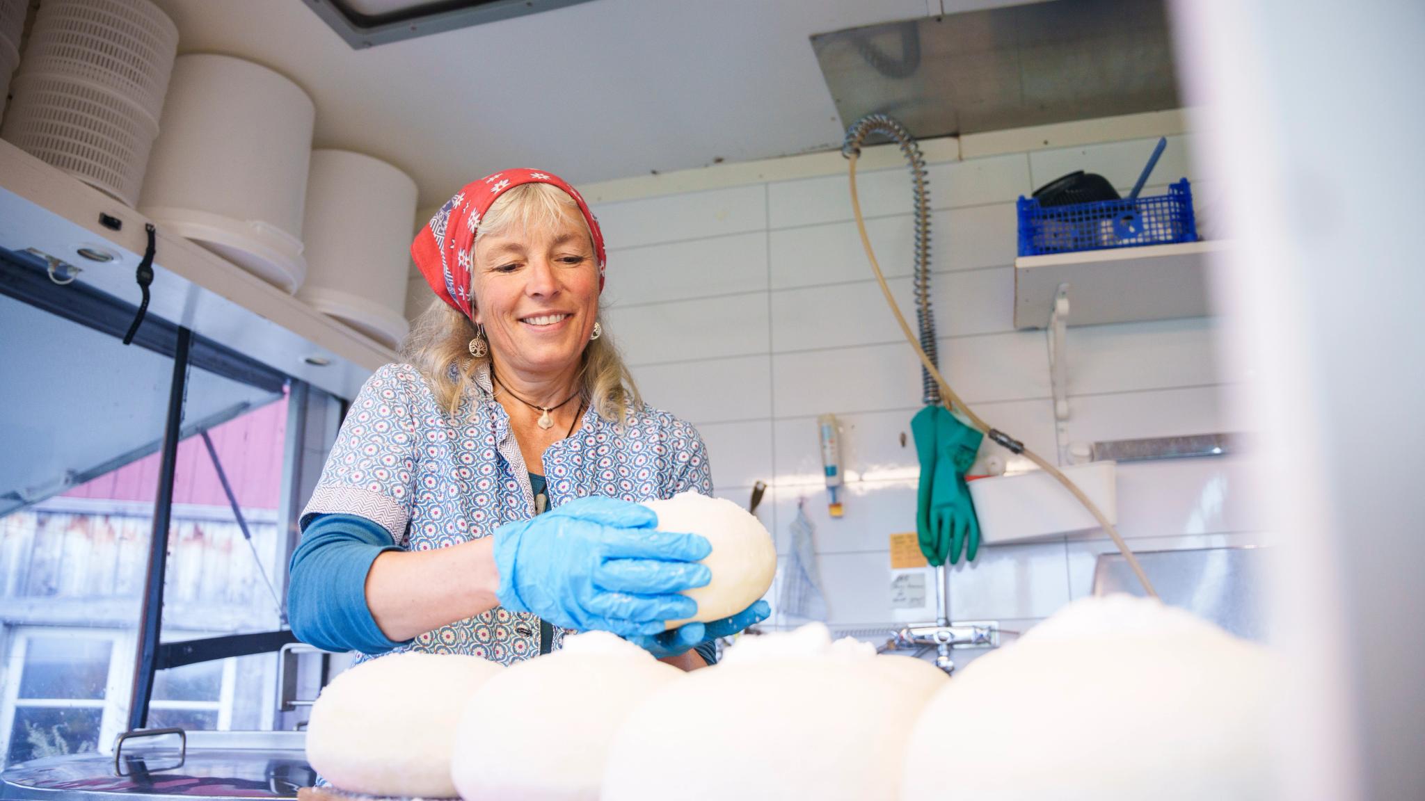 A woman making cheese at Nørretogo farm in Valdres