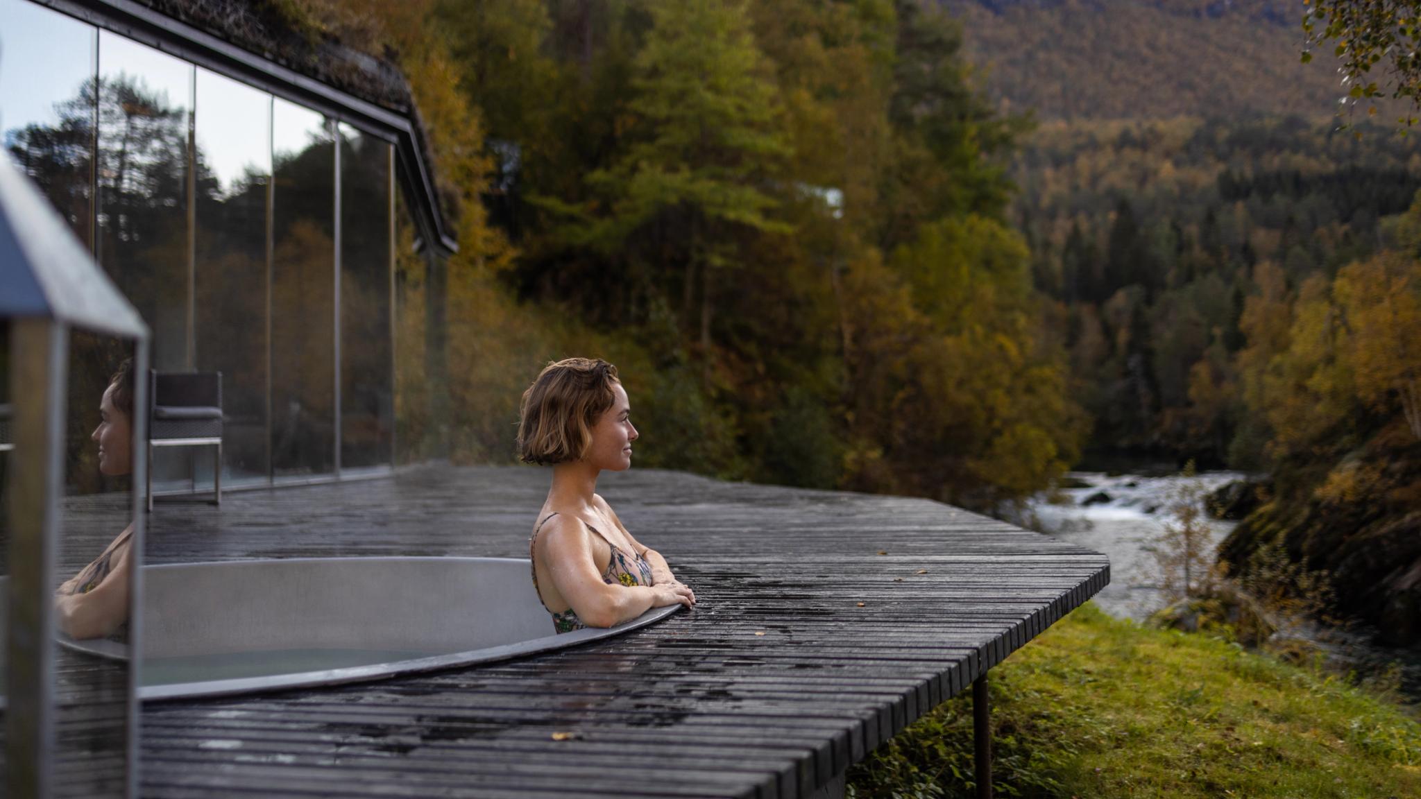 A women enjoying a bath in the spa area at Juvet Landskapshotell, Norway.