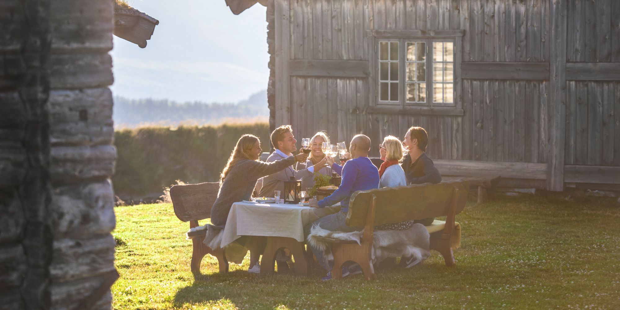 A group of people having dinner outdoors at Brekkeseter in the Rondane mountains, Eastern Norway