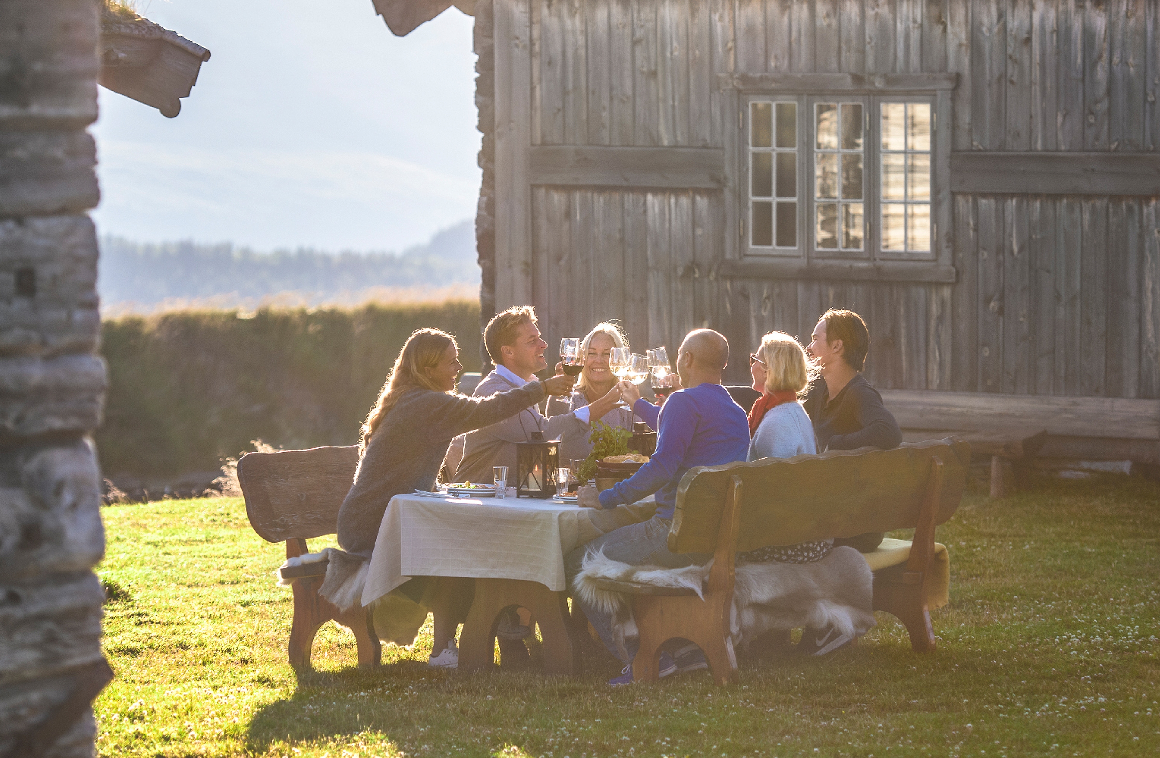 A group of people having dinner outdoors at Brekkeseter in the Rondane mountains, Eastern Norway