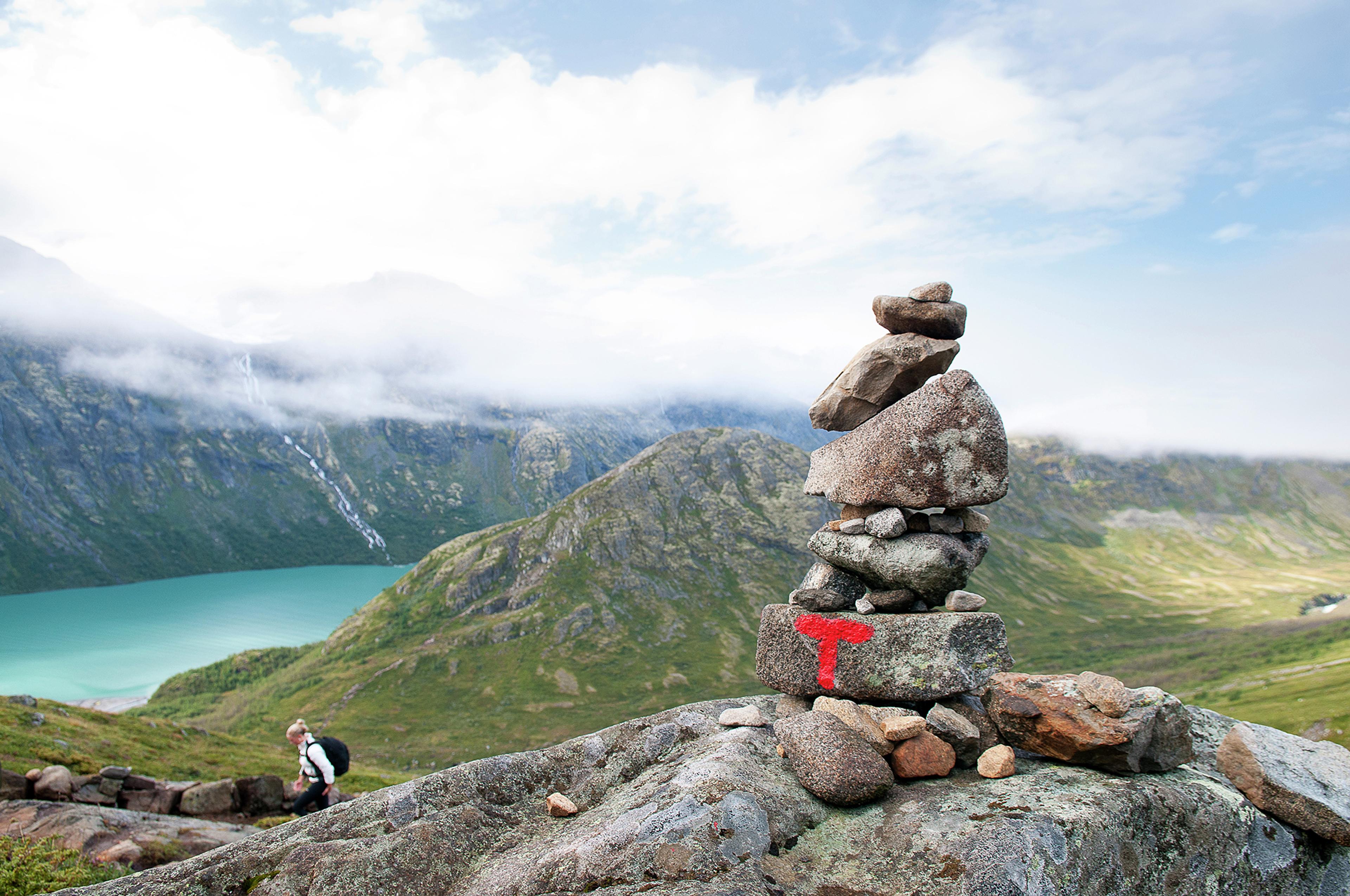 A pile of rocks with a sign on the hiking trail of the Besseggen ridge, Jotunheimen, Eastern Norway