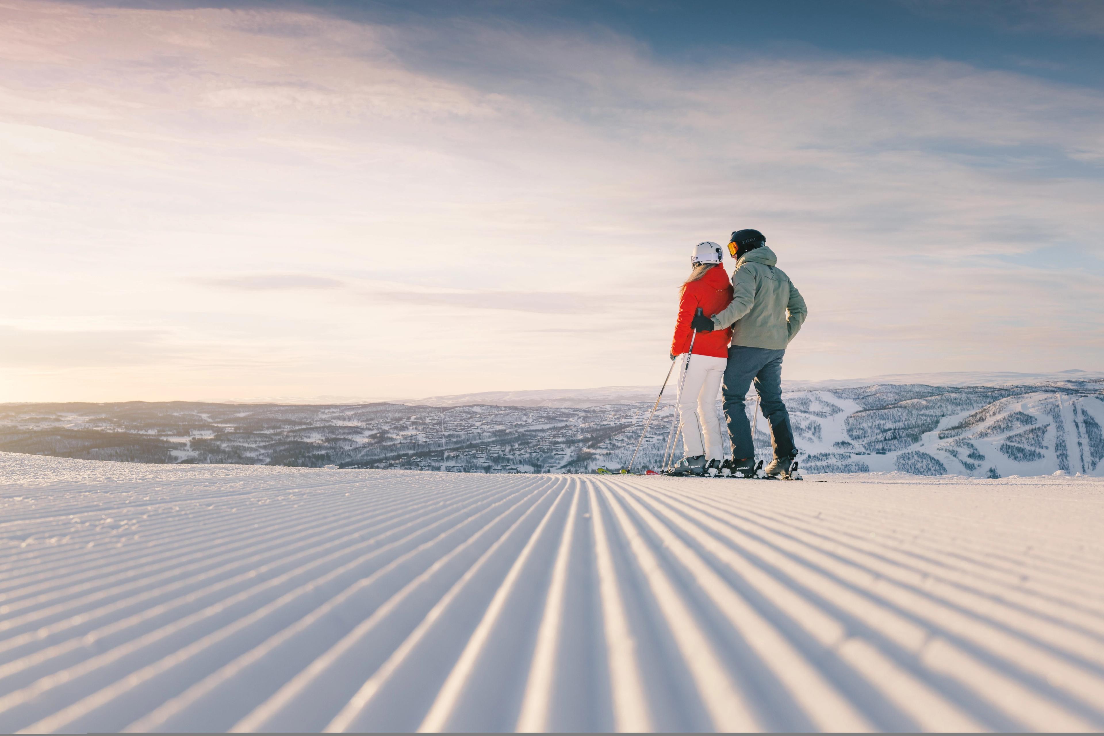 Couple standing in a freshly prepared ski slope in Geilo skiresort, Eastern Norway