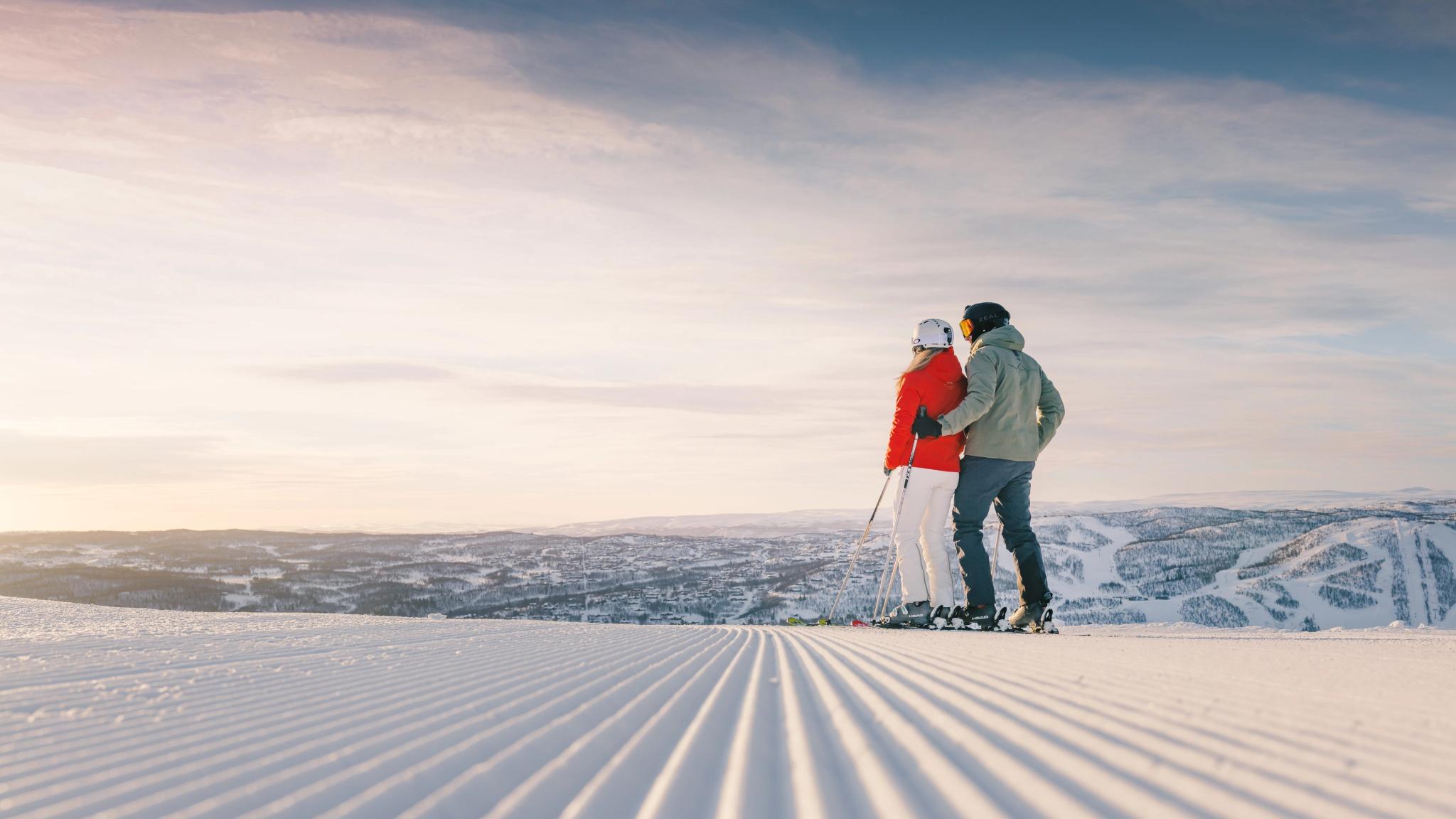 Couple standing in a freshly prepared ski slope in Geilo skiresort, Eastern Norway