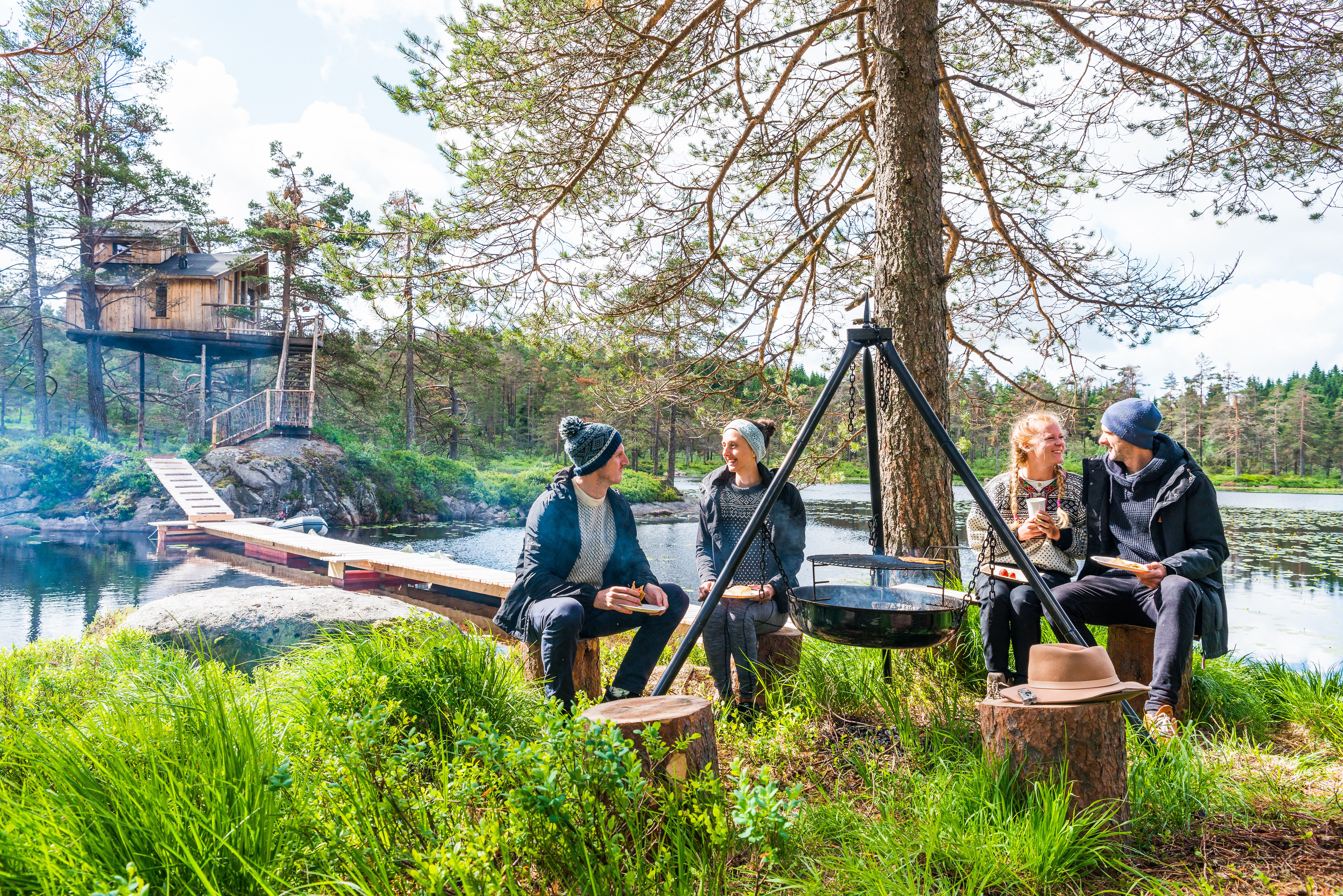 Friends eating around a bonfire at Fiddan in Lyngdal