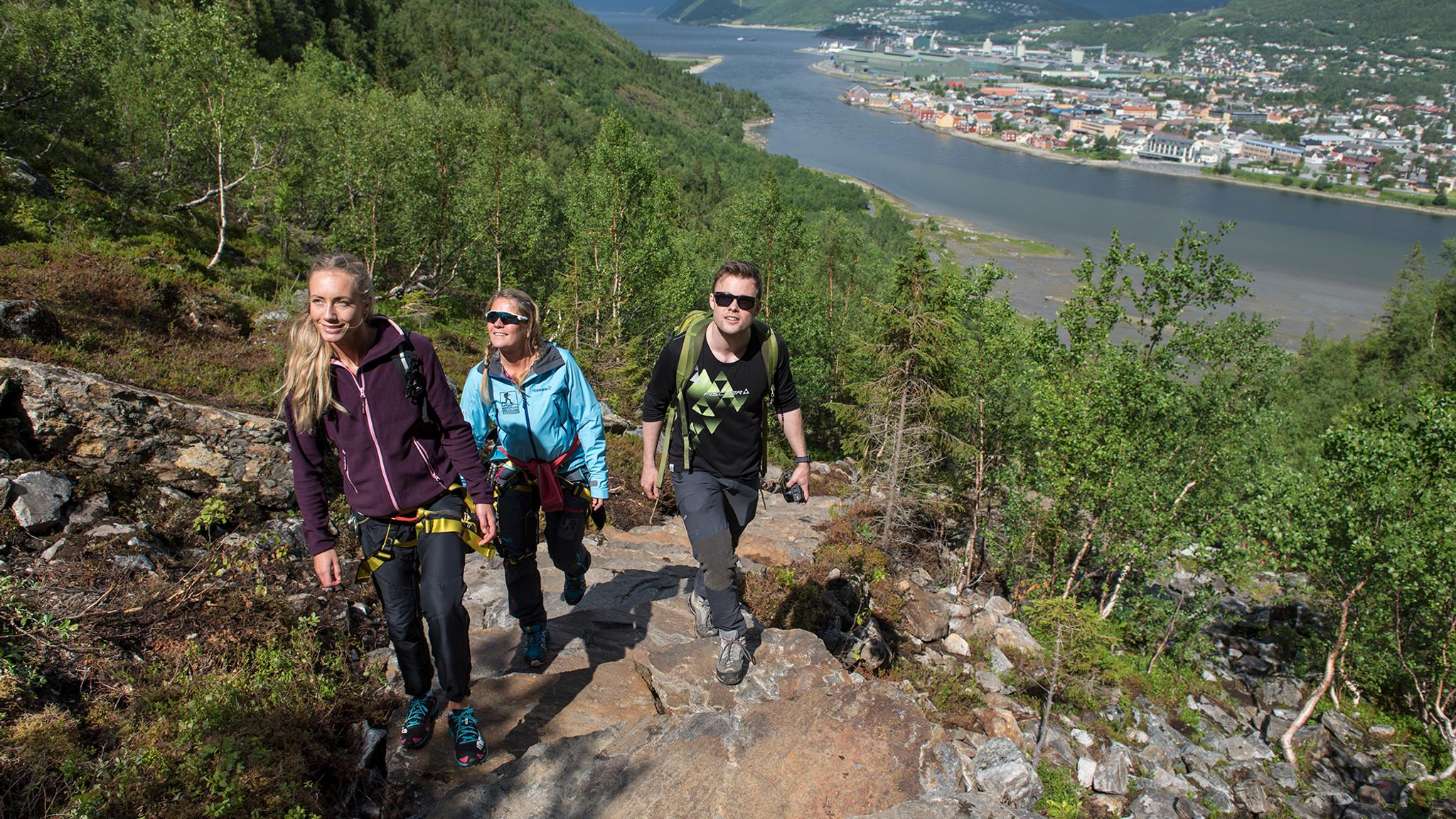 Three people hiking the Helgelandstrappa sherpa stairs in Mosjøen, Helgeland, Northern Norway