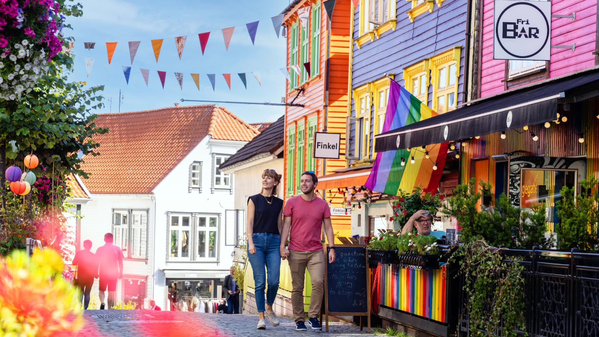 A couple walking in Fargegaten (the street of color)