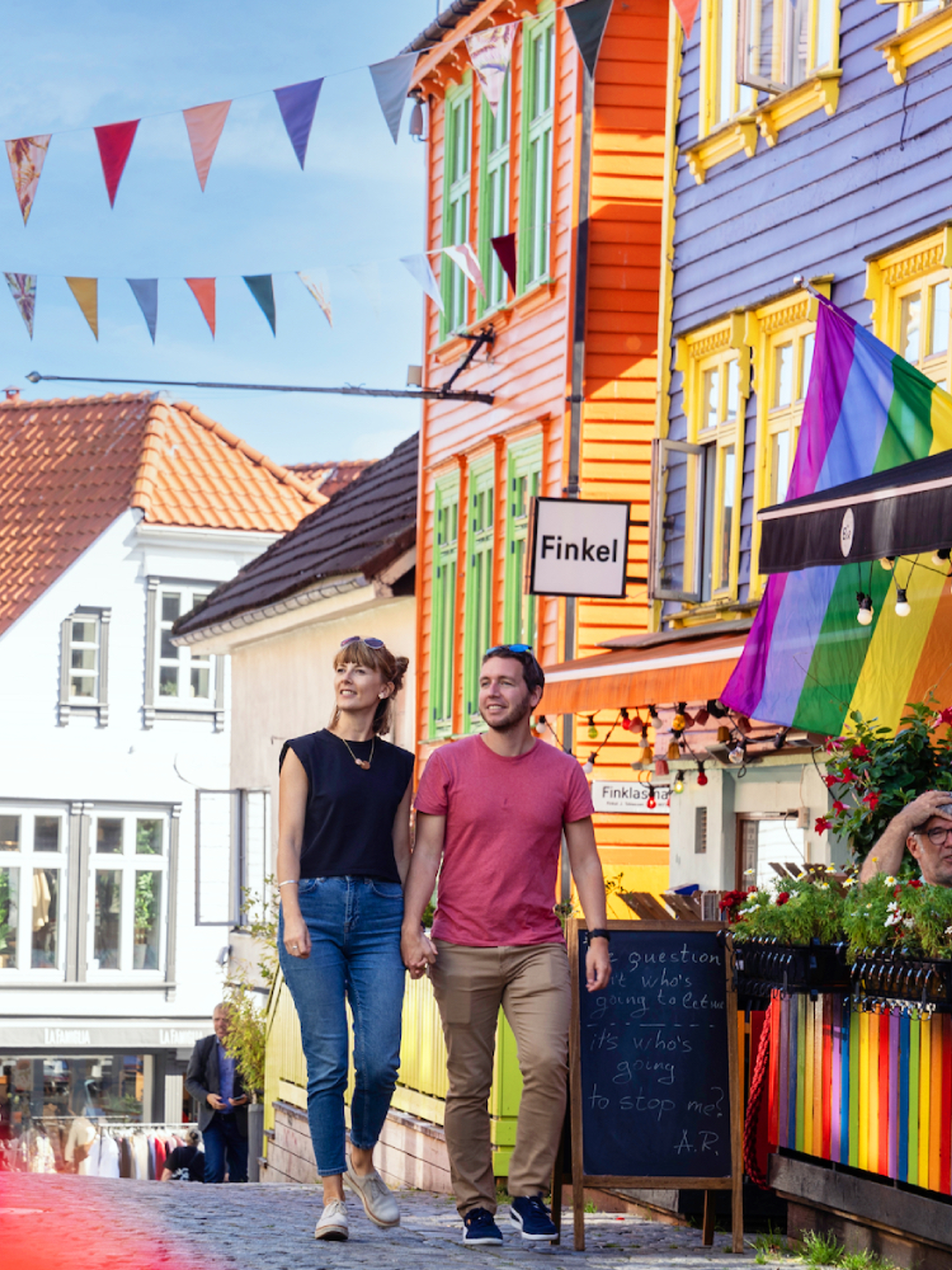 A couple walking in Fargegaten (the street of color)