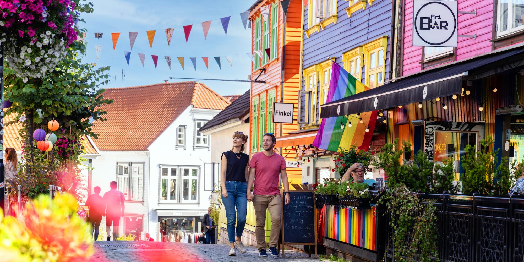 A couple walking in Fargegaten (the street of color)