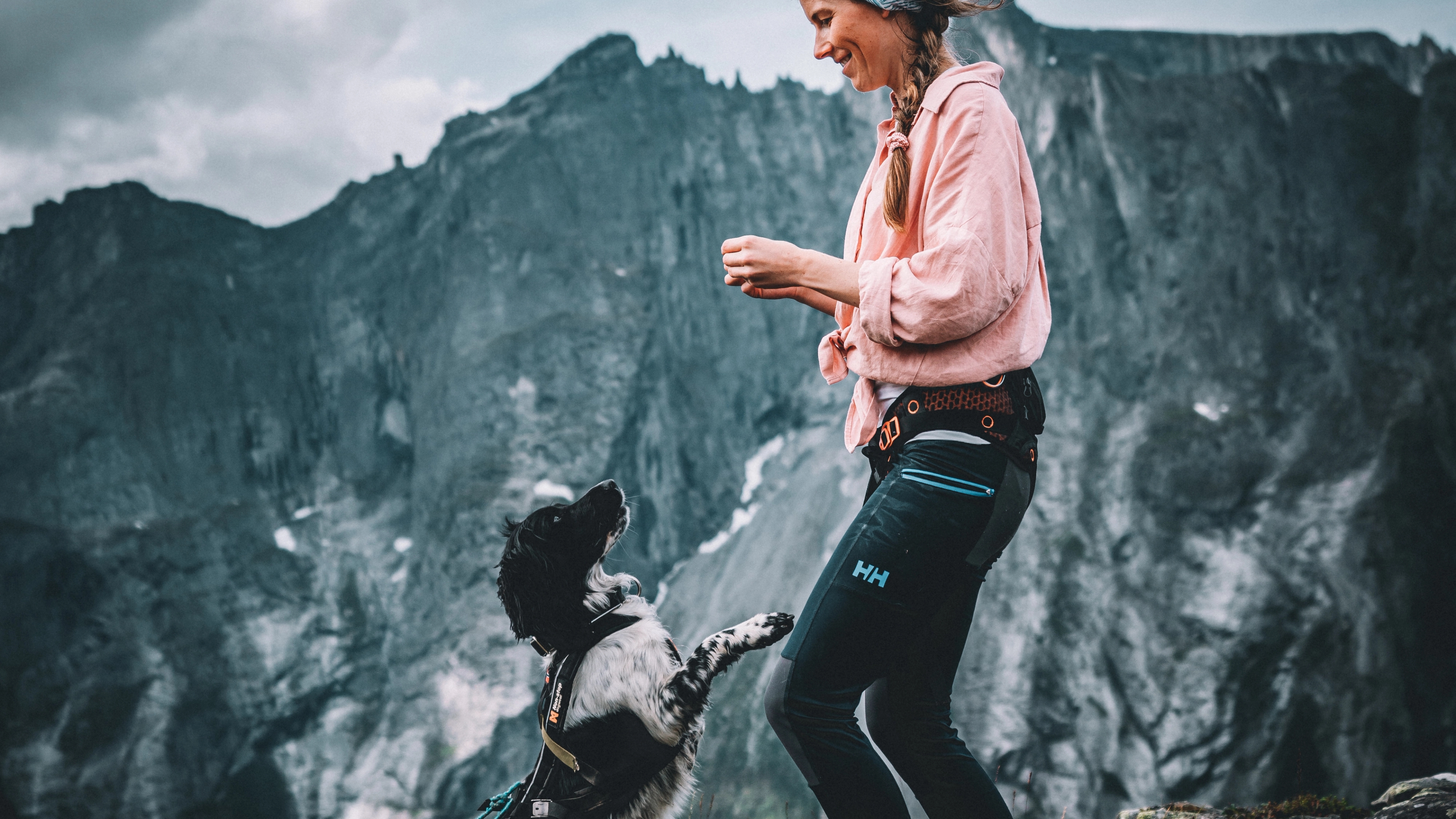 Dog and woman playing at Litlefjellet mountain, Romsdal