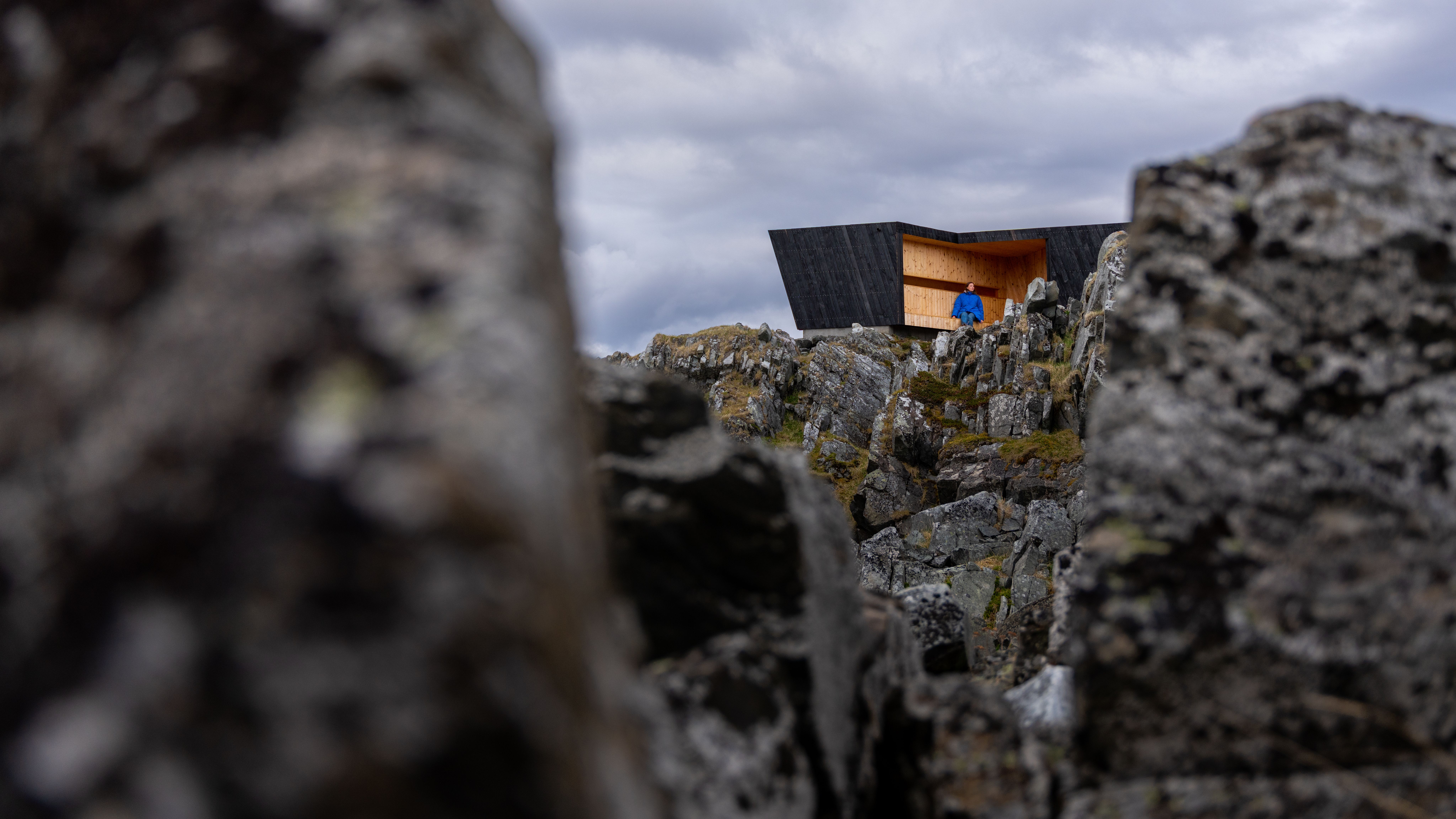 A woman in a birdwatching hide made by Biotope in Hamningberg, Varanger, Northern Norway