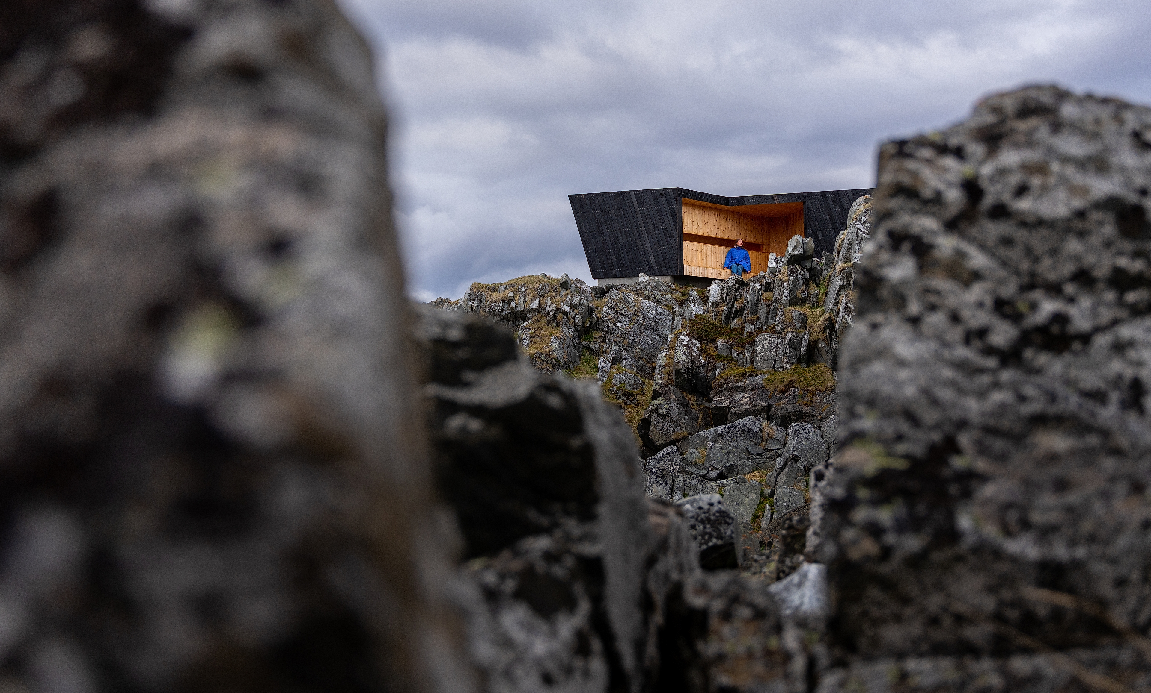 A woman in a birdwatching hide made by Biotope in Hamningberg, Varanger, Northern Norway