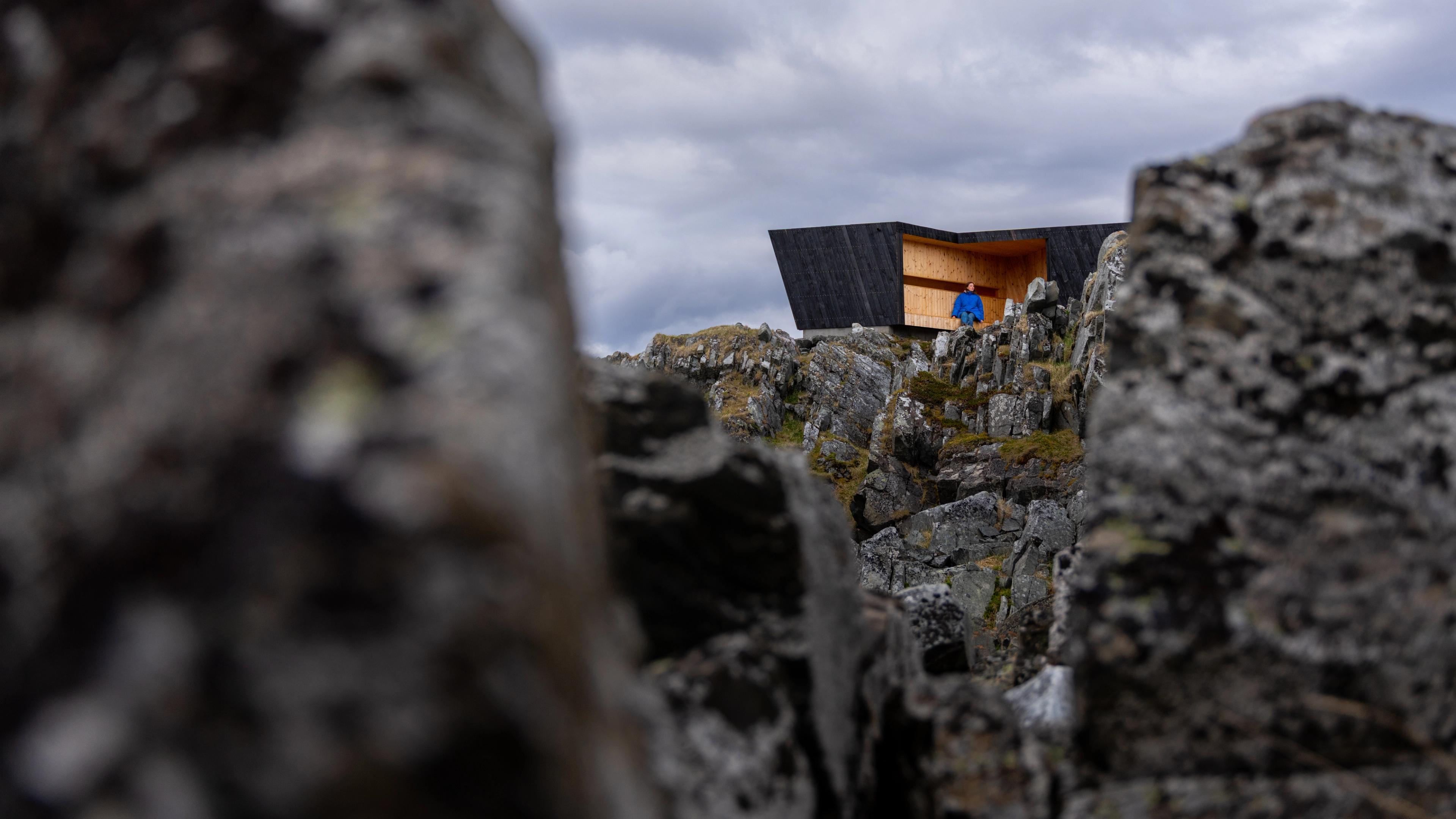 A woman in a birdwatching hide made by Biotope in Hamningberg, Varanger, Northern Norway