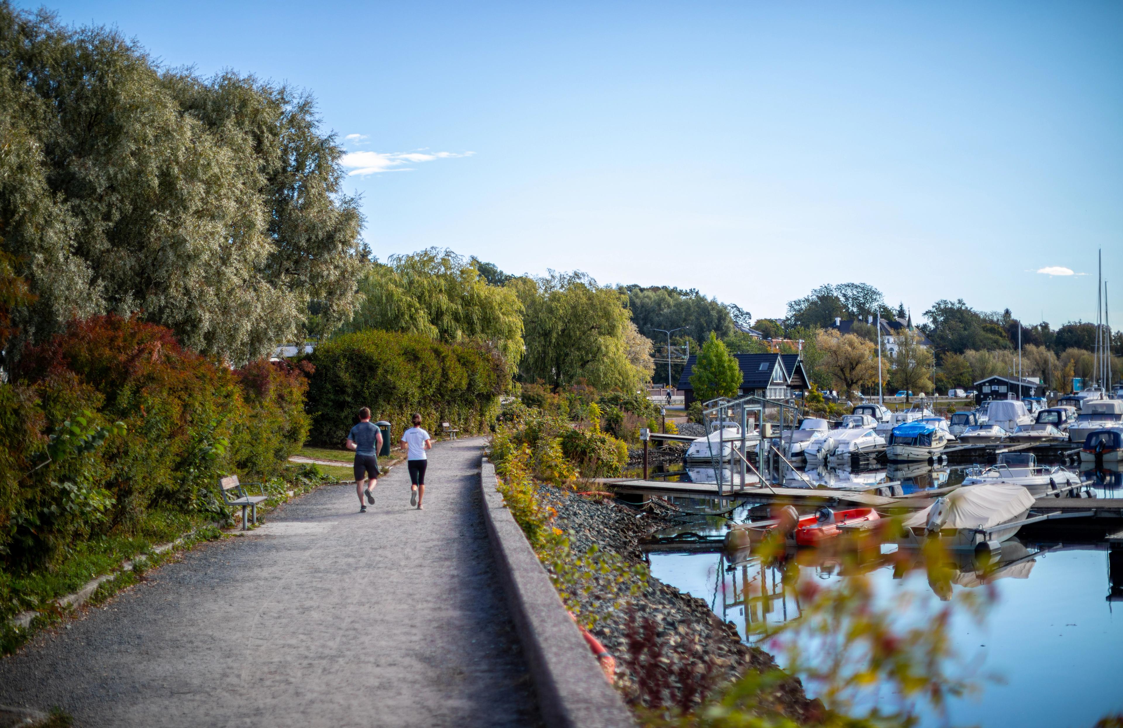 Two people running at the Frognerkilen promenade in Oslo, Eastern Norway