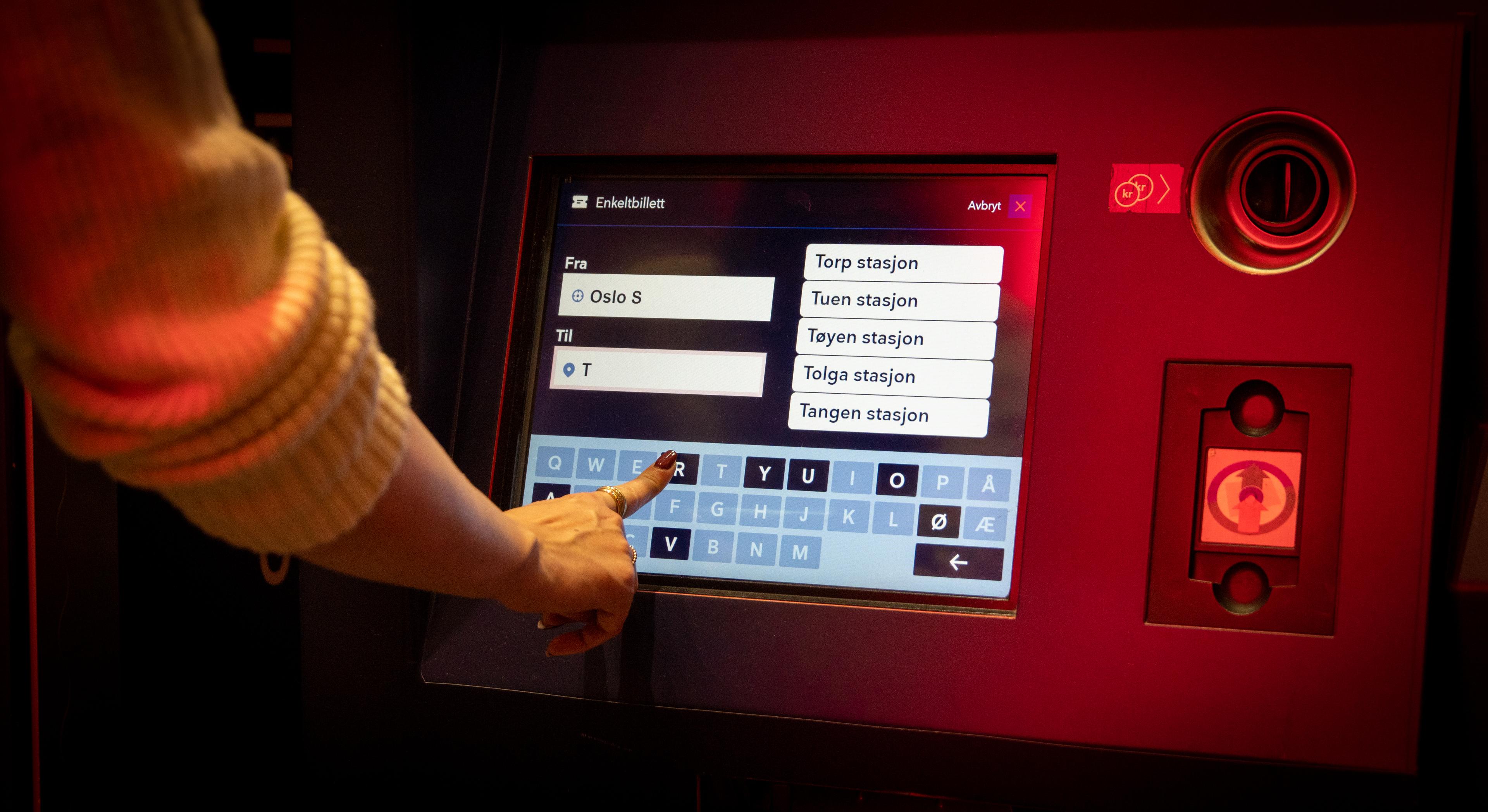 A woman buying train tickets.