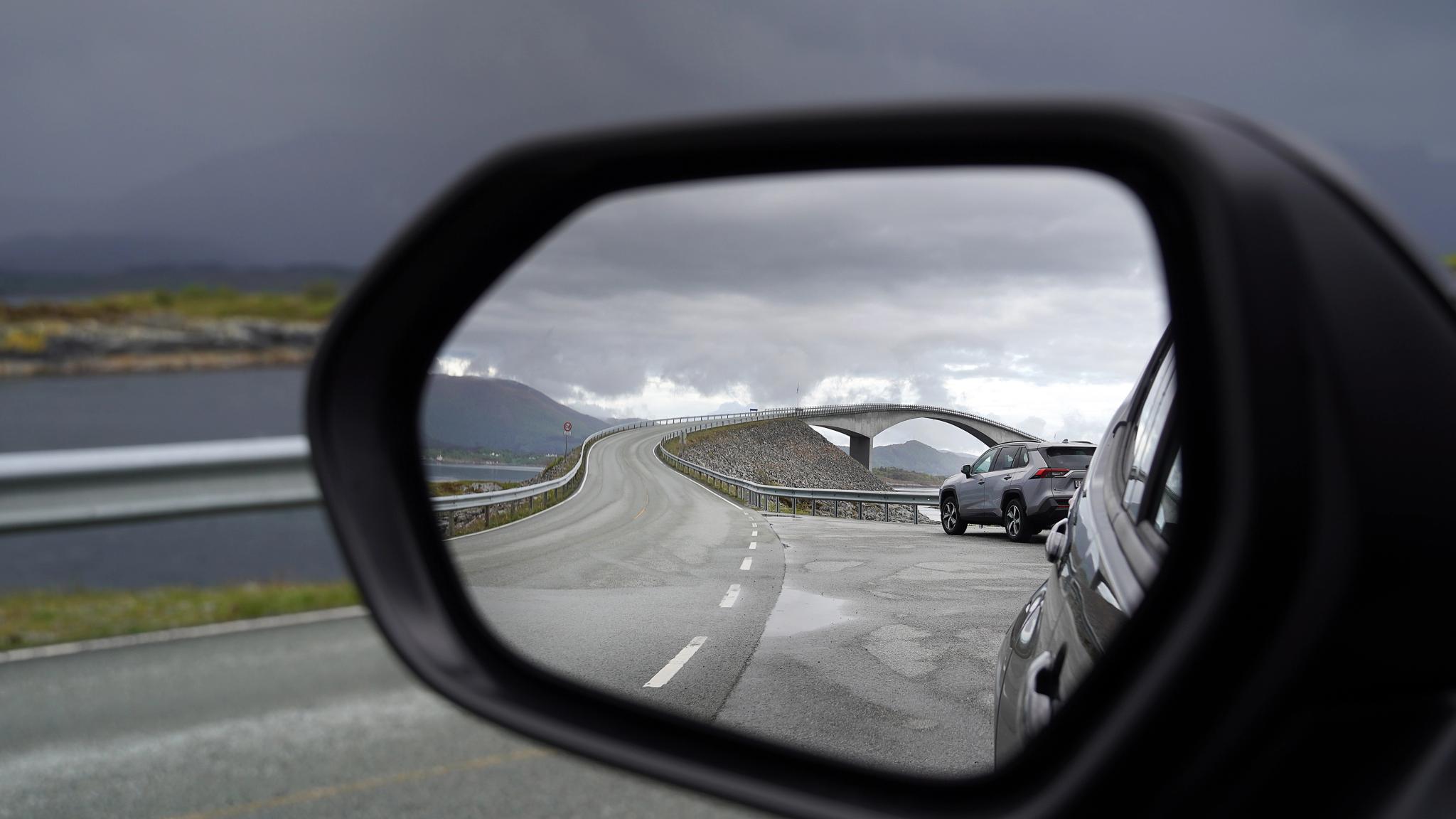 The bridge of the Atlantic road reflected in a car mirror
