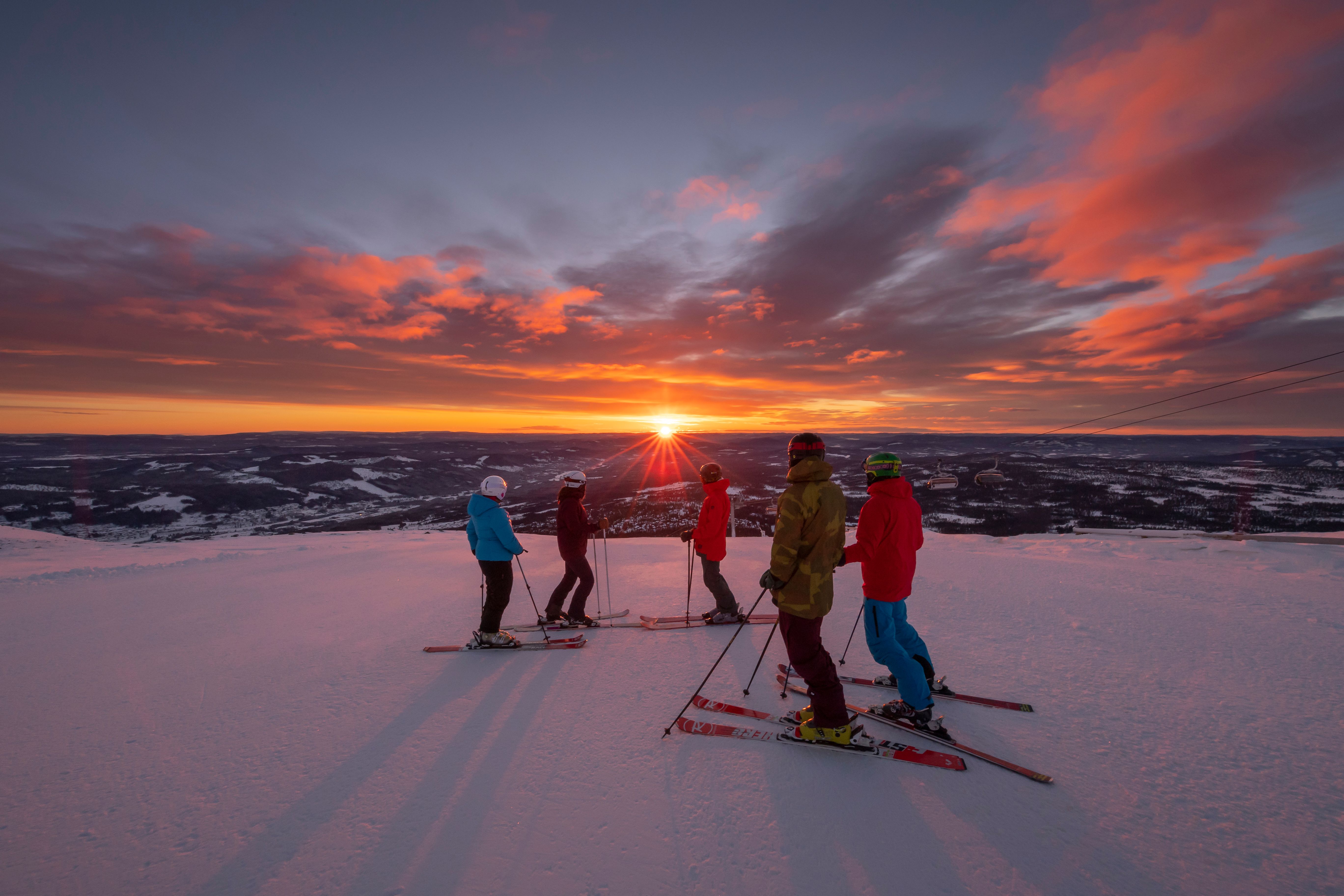 People enjoying the sunset from the slopes at Trysil ski resort in Eastern Norway