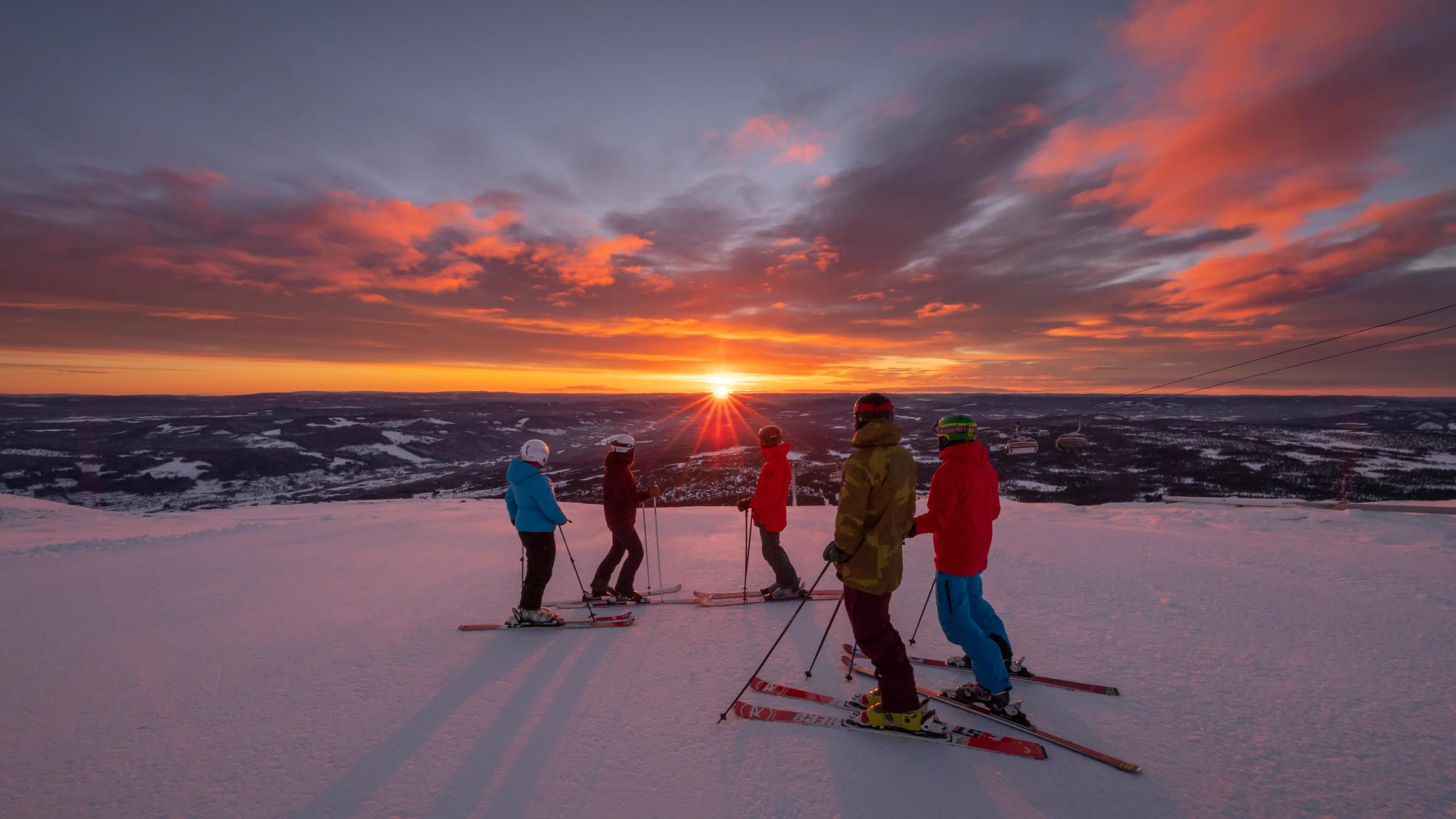 People enjoying the sunset from the slopes at Trysil ski resort in Eastern Norway